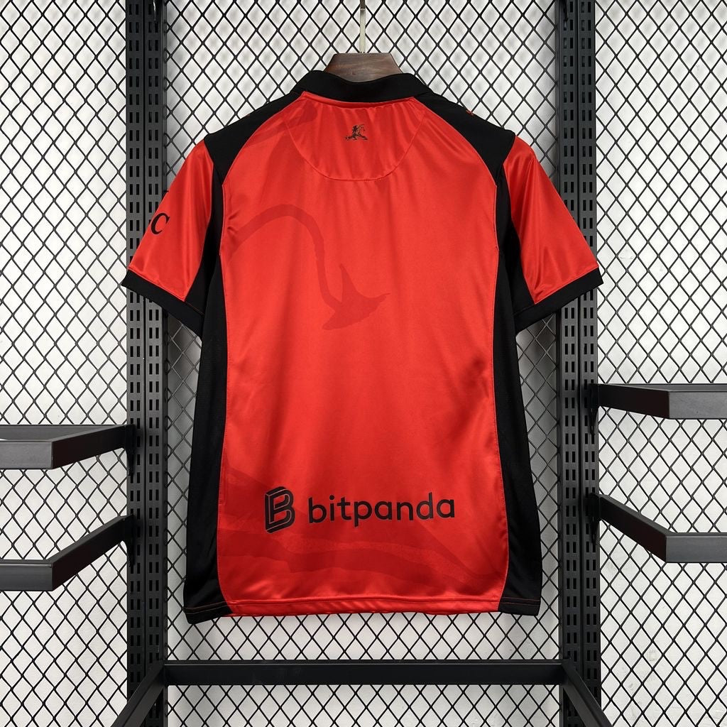 Leazofoot AC Milan 26/27 third football jersey in red and black with sponsor logo, back view on a display rack.