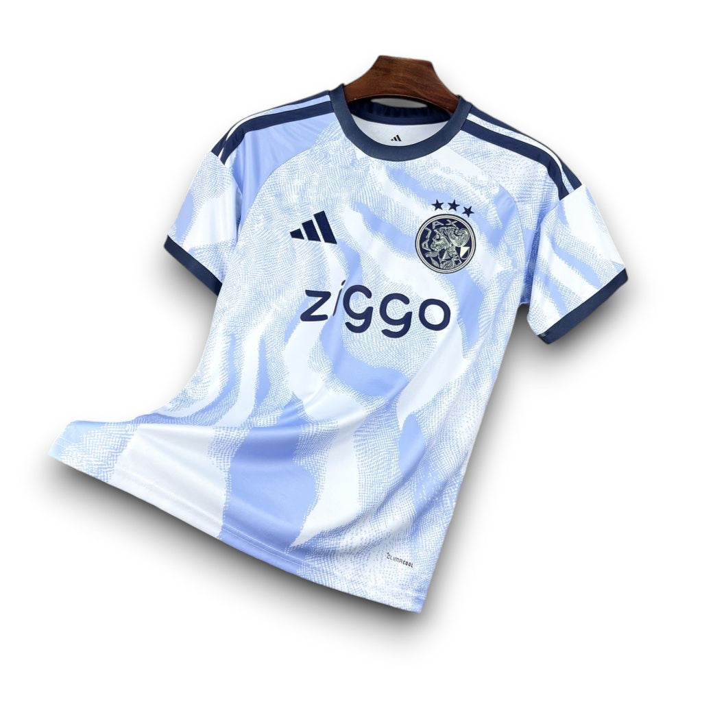 Leazofoot AJAX 26/27 third football jersey, light blue with white abstract pattern, navy trim, Ziggo sponsor.