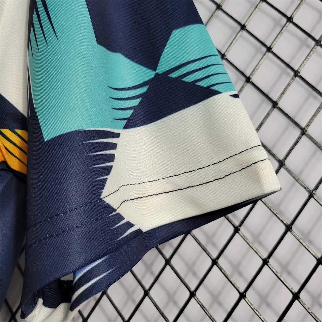 Leazofoot Algeria 2022 training jersey sleeve with navy, teal, and white geometric pattern and yellow accents.