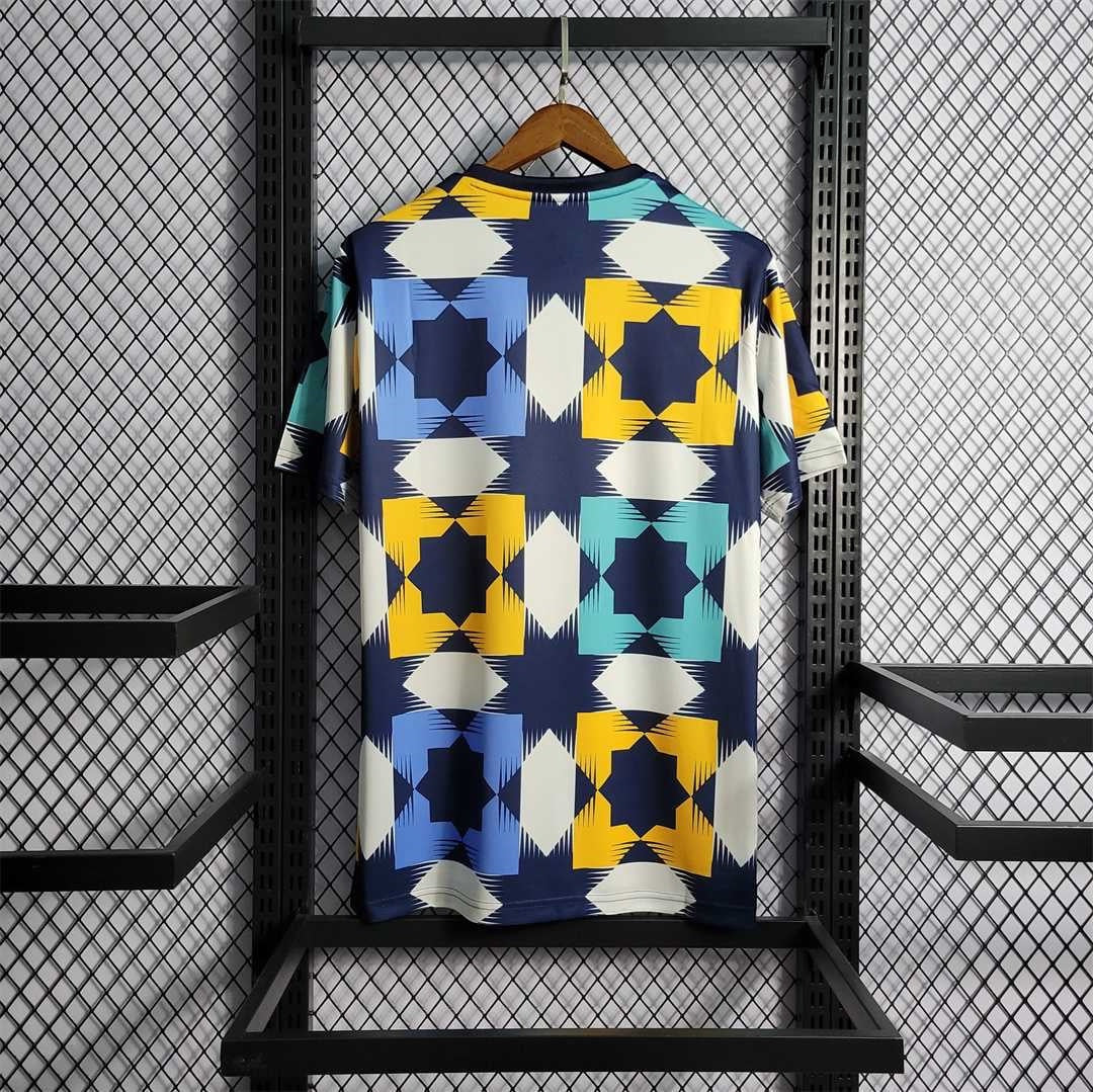 Leazofoot Algeria 2022 training jersey featuring a blue, yellow, and white geometric star pattern on a hanger.