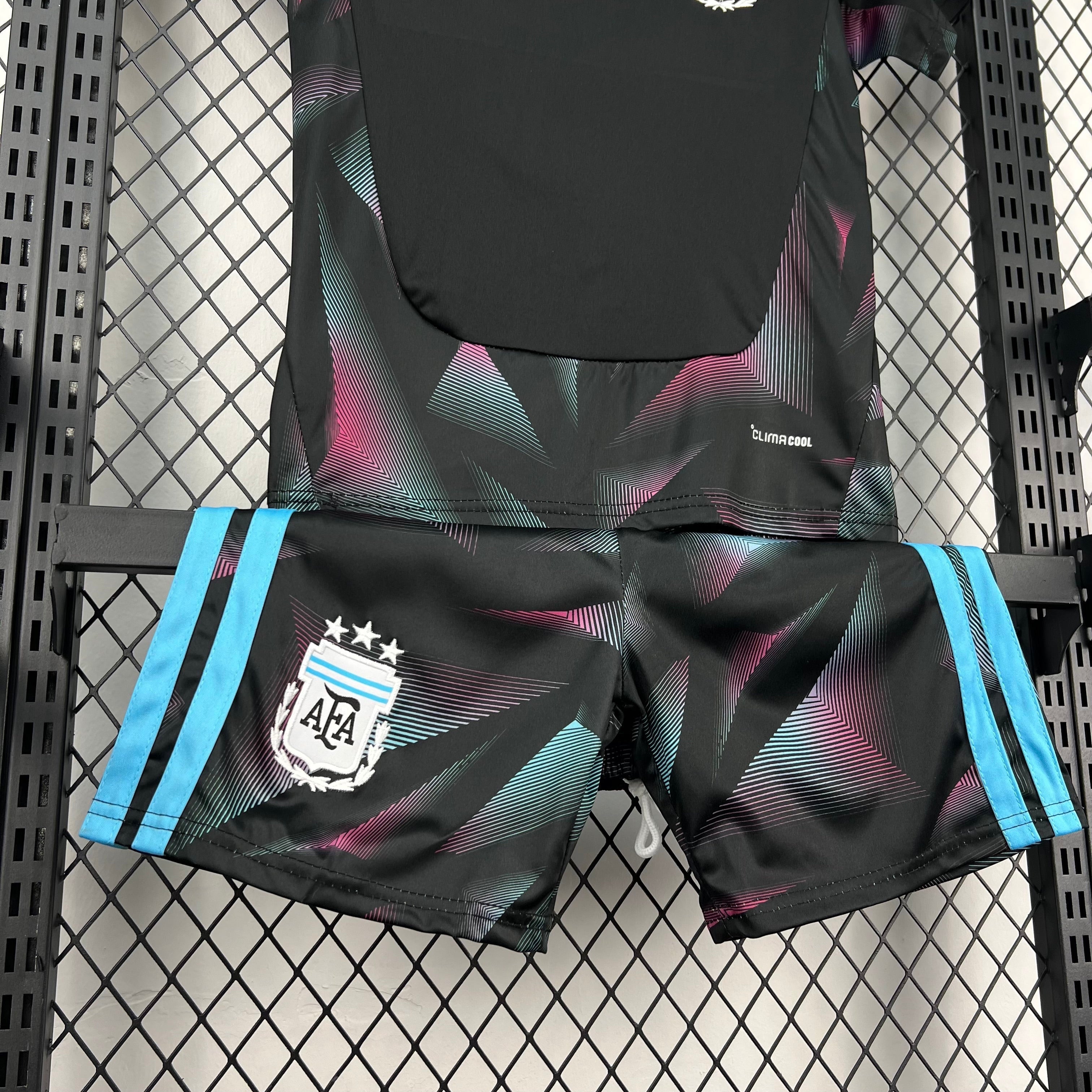 Leazofoot black child's football kit with geometric pattern in pink and teal, featuring the AFA crest.