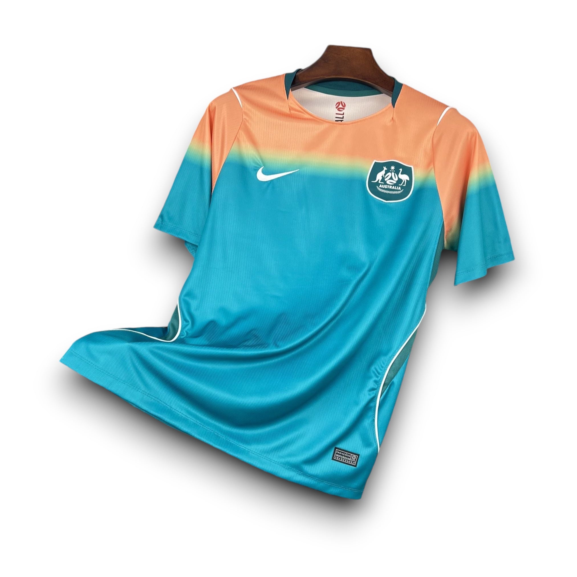 Leazofoot Australia 2026 men's soccer jersey, teal with orange gradient sleeves and white accents.