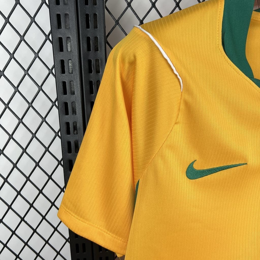 Leazofoot Australia 2026 home soccer jersey in yellow with green trim and Nike logo.