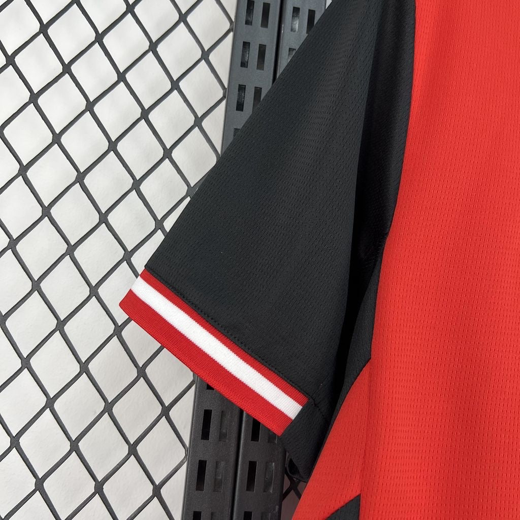 Leazofoot Austria 2026 home soccer jersey featuring a red body, black sleeves, and red-white-red striped cuffs.