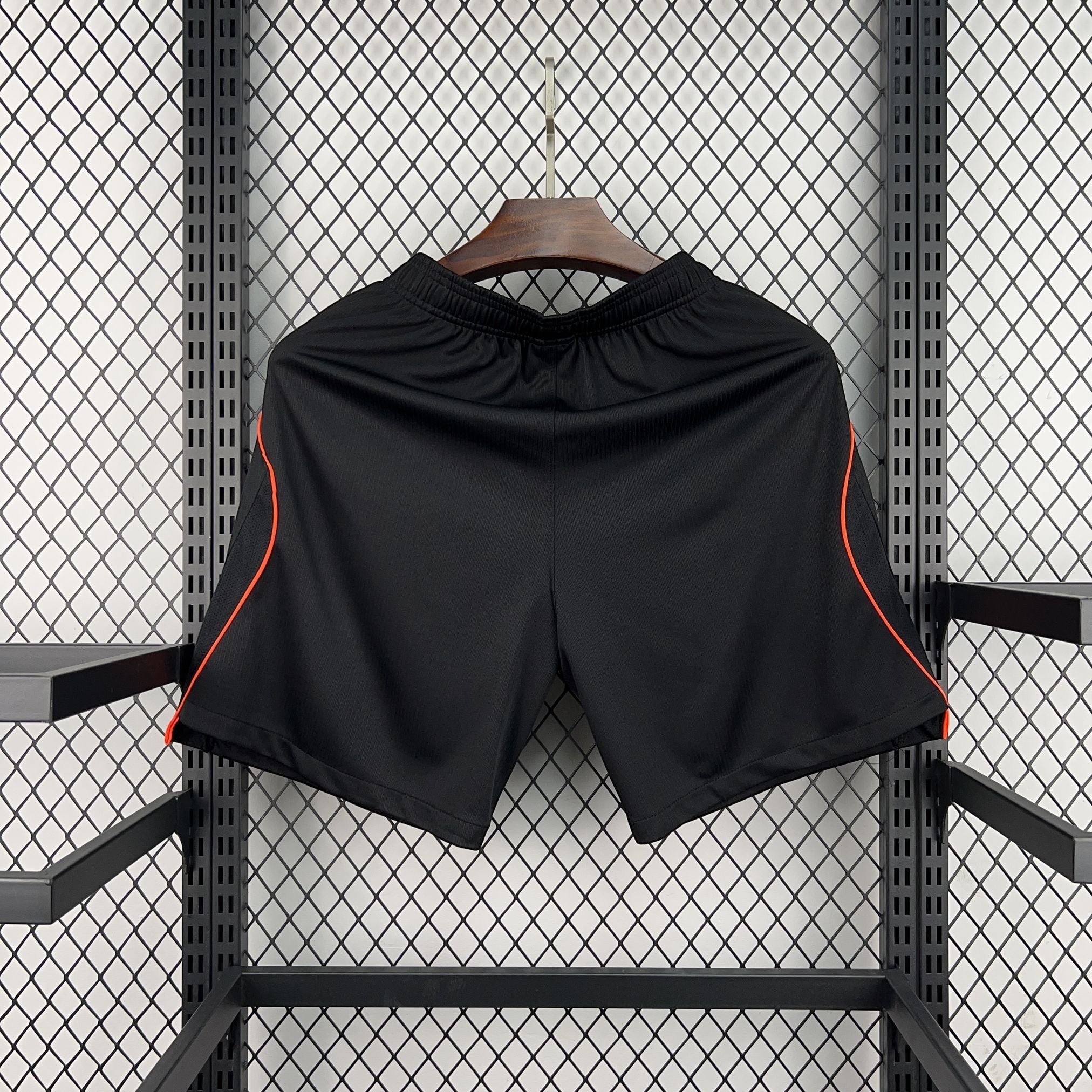 Leazofoot black athletic shorts with orange trim detail on the sides, elastic waistband.