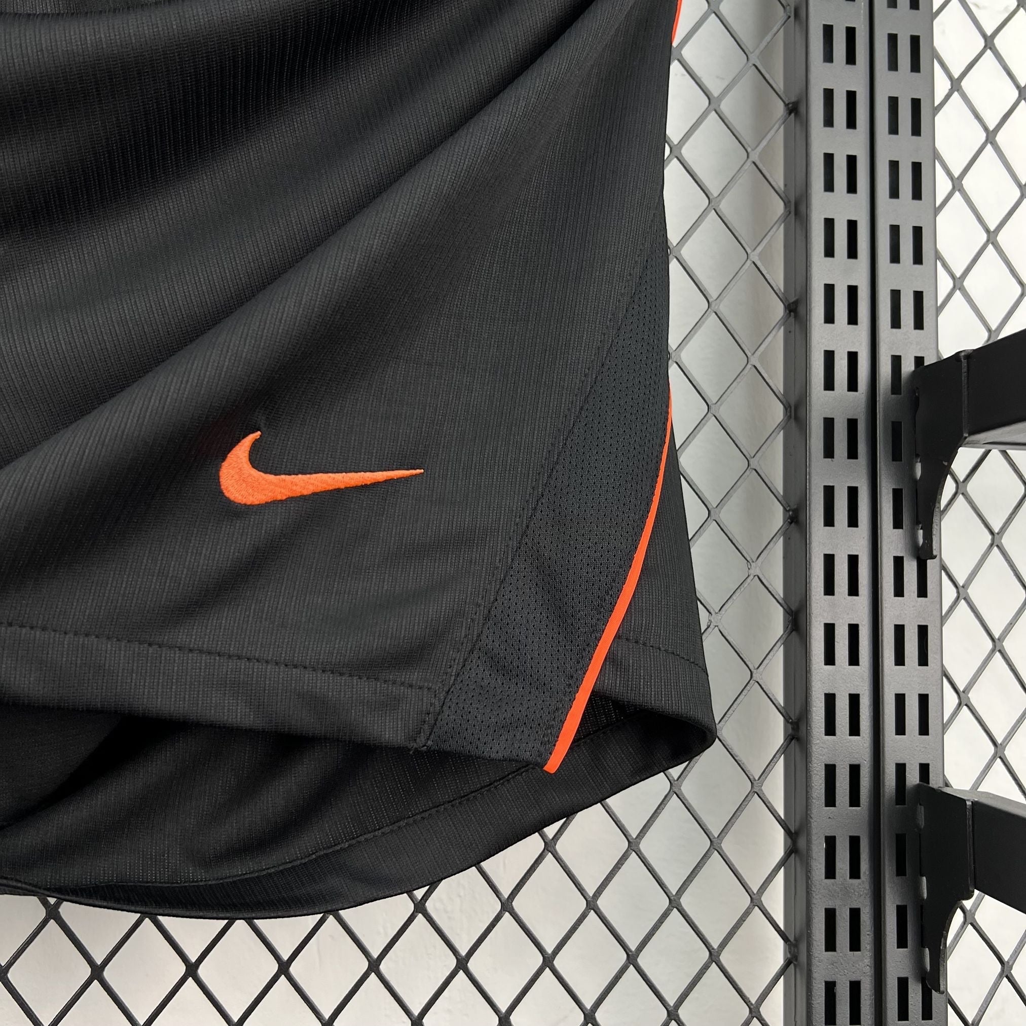 Leazofoot black athletic shorts with orange trim and embroidered Nike swoosh logo.
