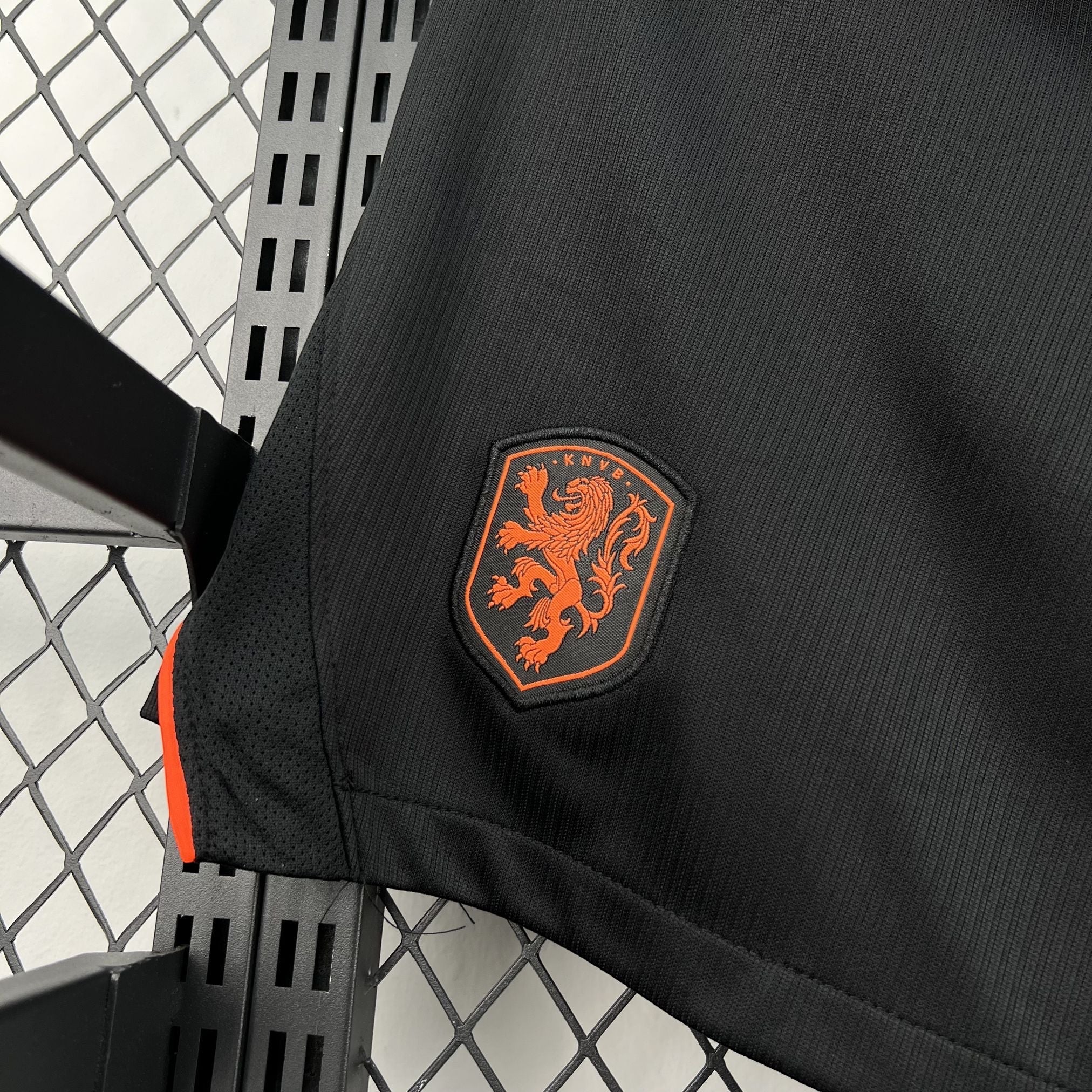 Leazofoot black football shorts with orange lion crest and mesh side panels