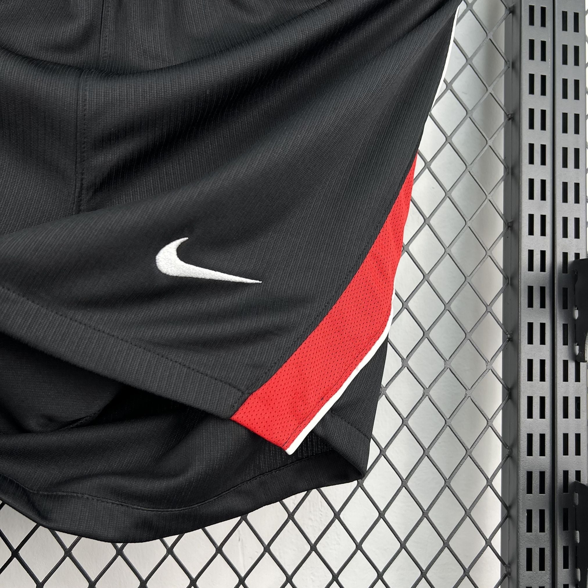 Leazofoot black athletic shorts with white Nike logo and red side stripe detail.