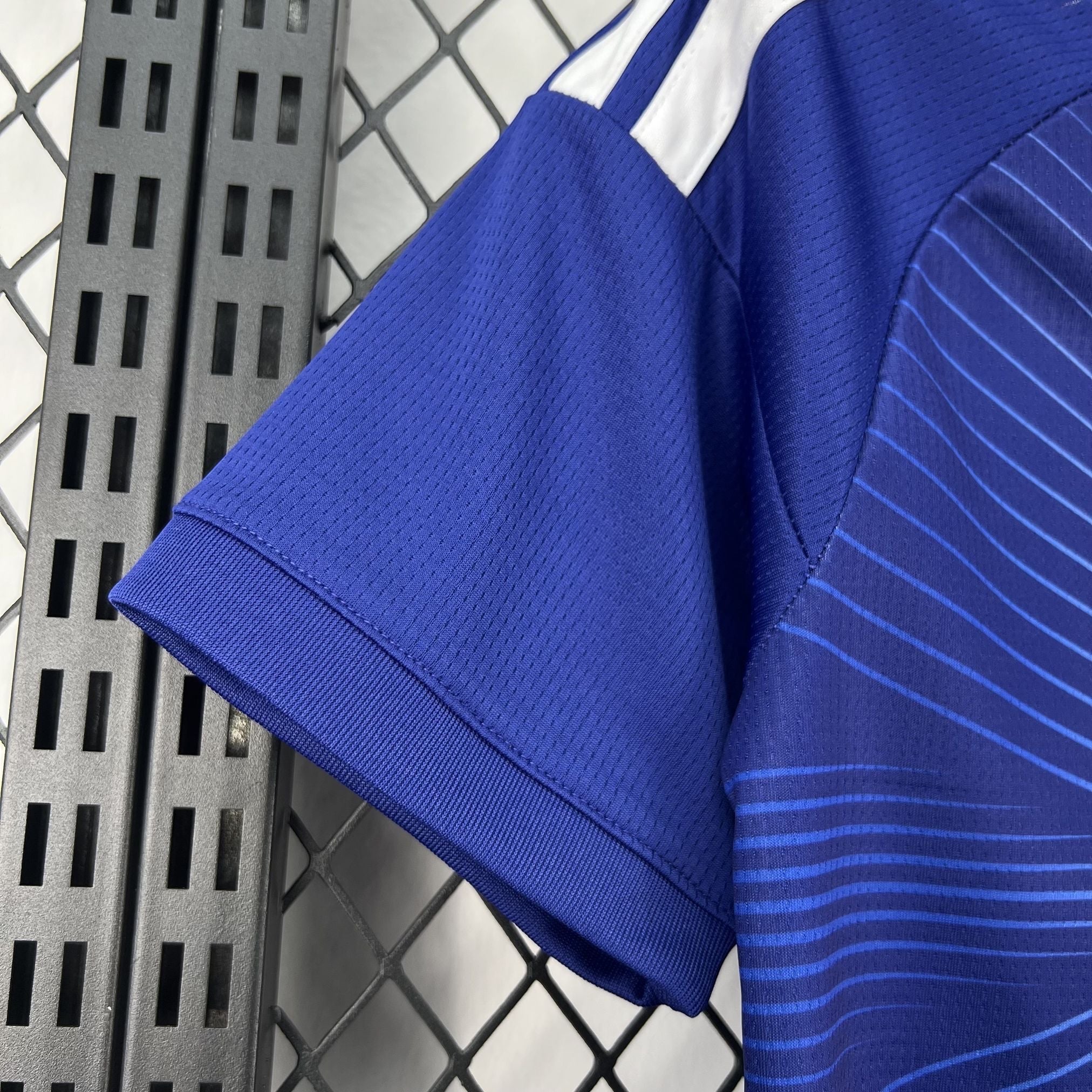 Leazofoot blue polyester kids' soccer jersey with white stripes on the shoulders and a striped pattern.
