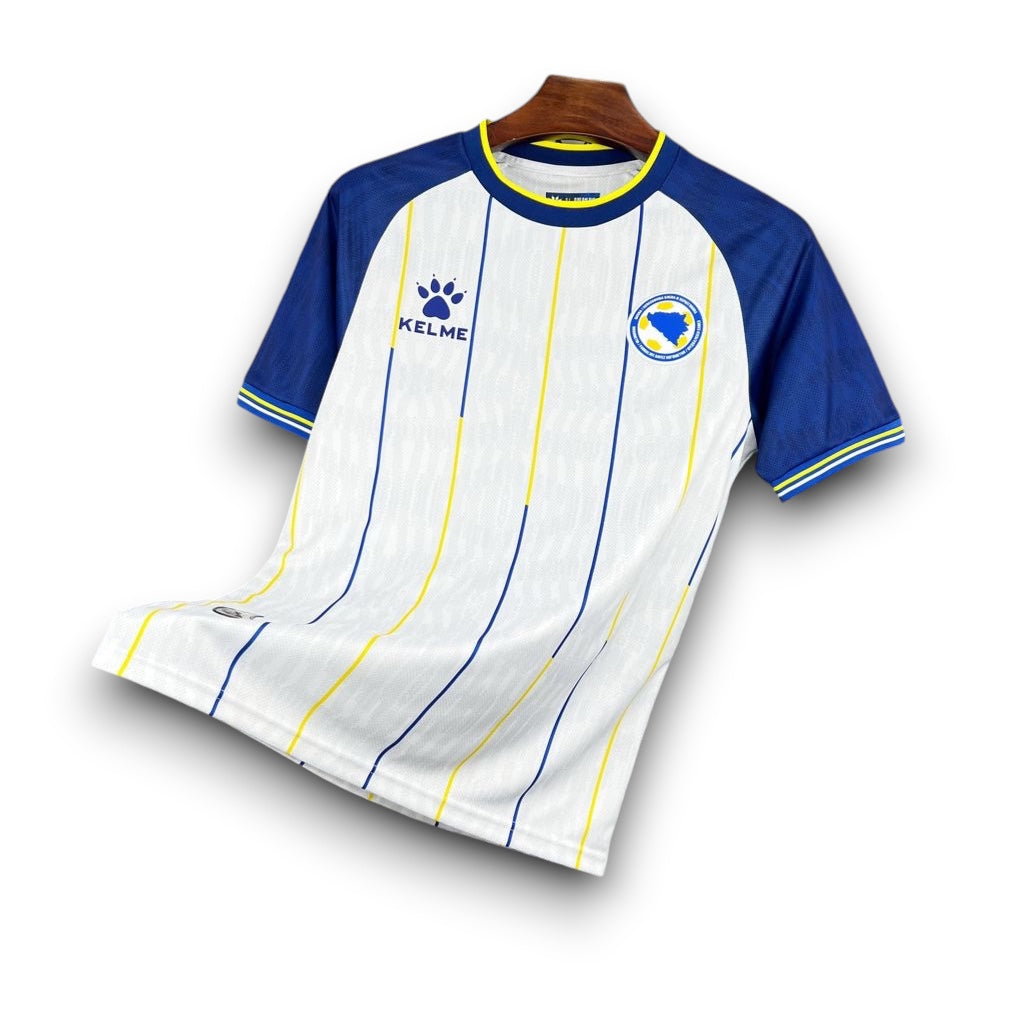 Leazofoot BOSNIE 2026 away jersey with white, blue, and yellow vertical stripes. Features blue sleeves and trim.