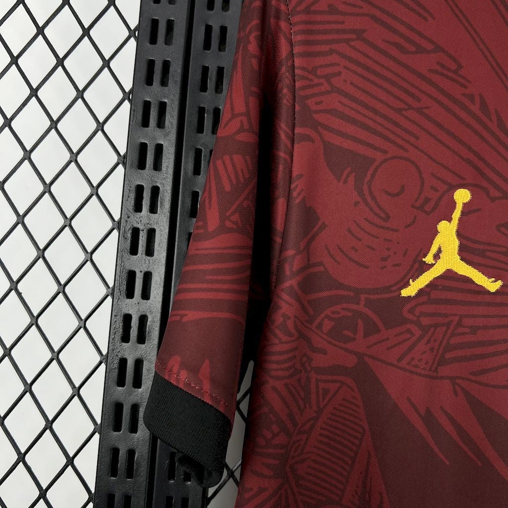 Leazofoot Brasil 2024 concept soccer jersey in maroon with yellow Jumpman logo and intricate graphic pattern.