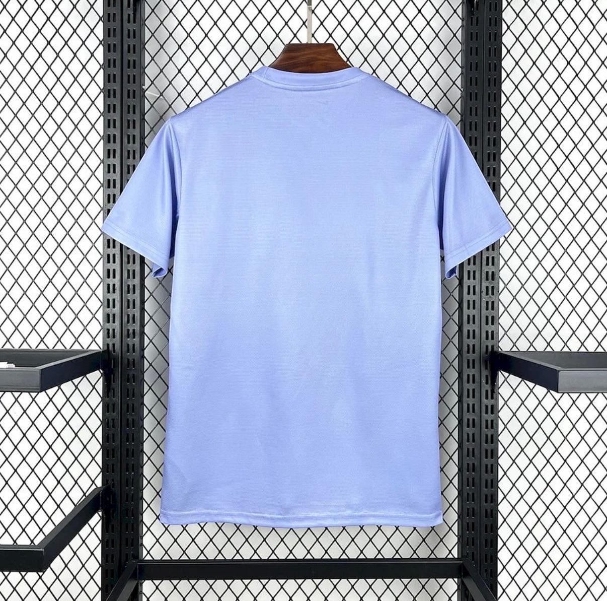 Back view of Leazofoot BRÉSIL 2025 concept soccer jersey in light blue performance fabric on a display rack.