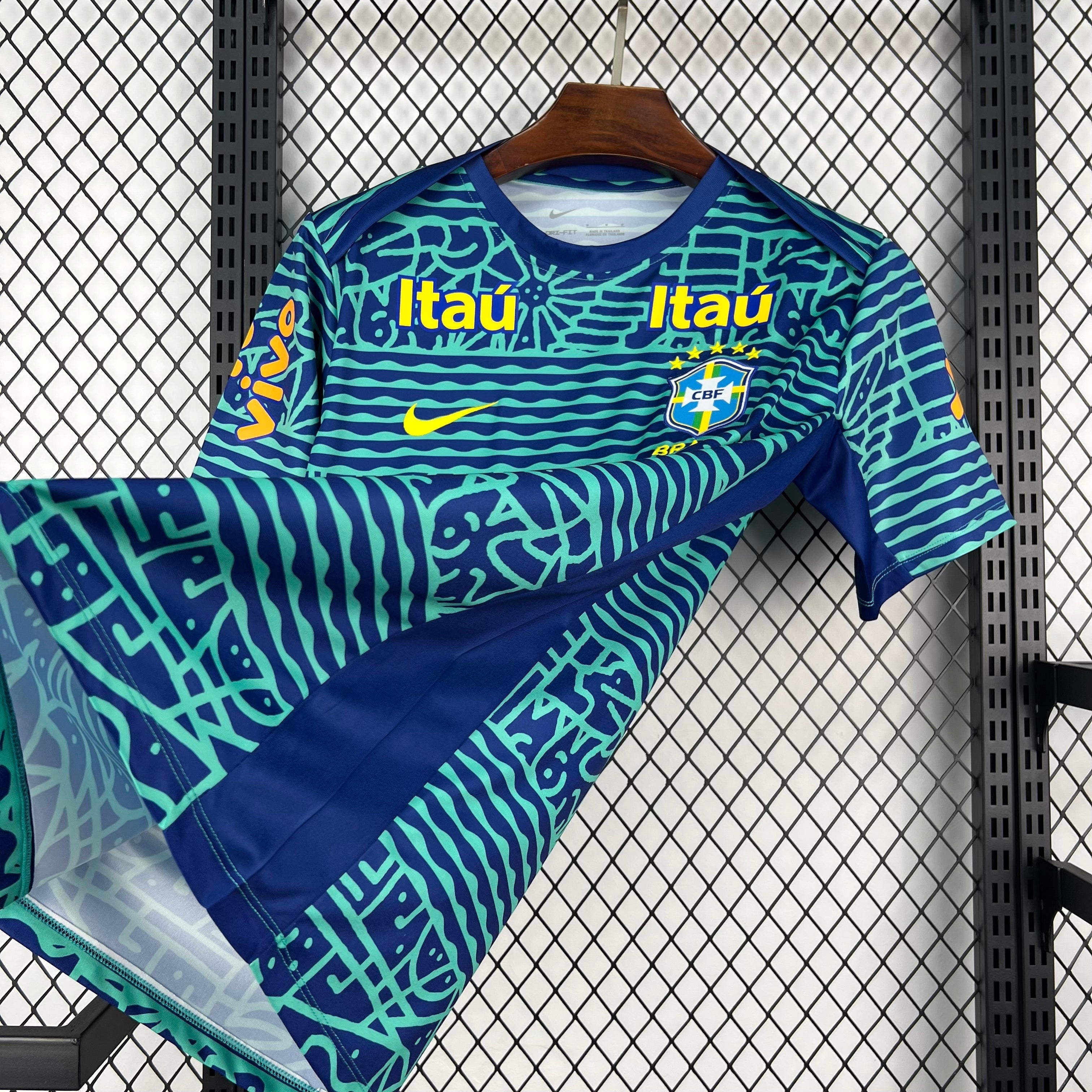 Leazofoot BRÉSIL 2026 pre-match football jersey in navy blue with teal abstract pattern and yellow accents.