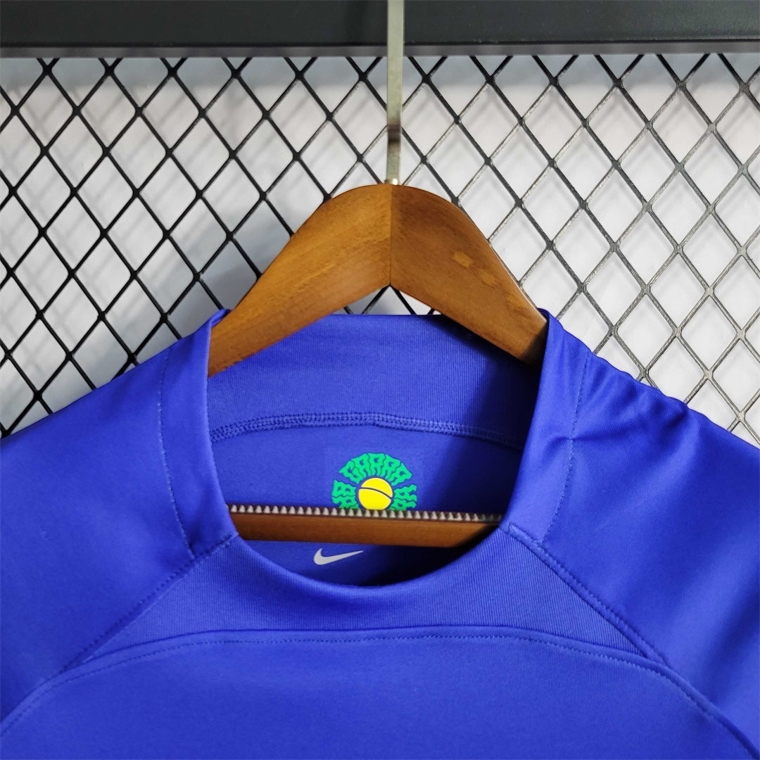 Leazofoot Brazil 2022 away soccer jersey in blue with inner neck graphic detail and Nike logo on a wooden hanger.