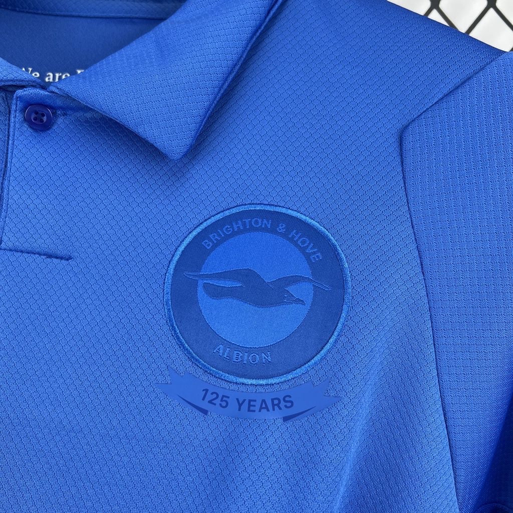 Leazofoot Brighton 125th anniversary blue polo shirt with textured fabric and embroidered club crest.