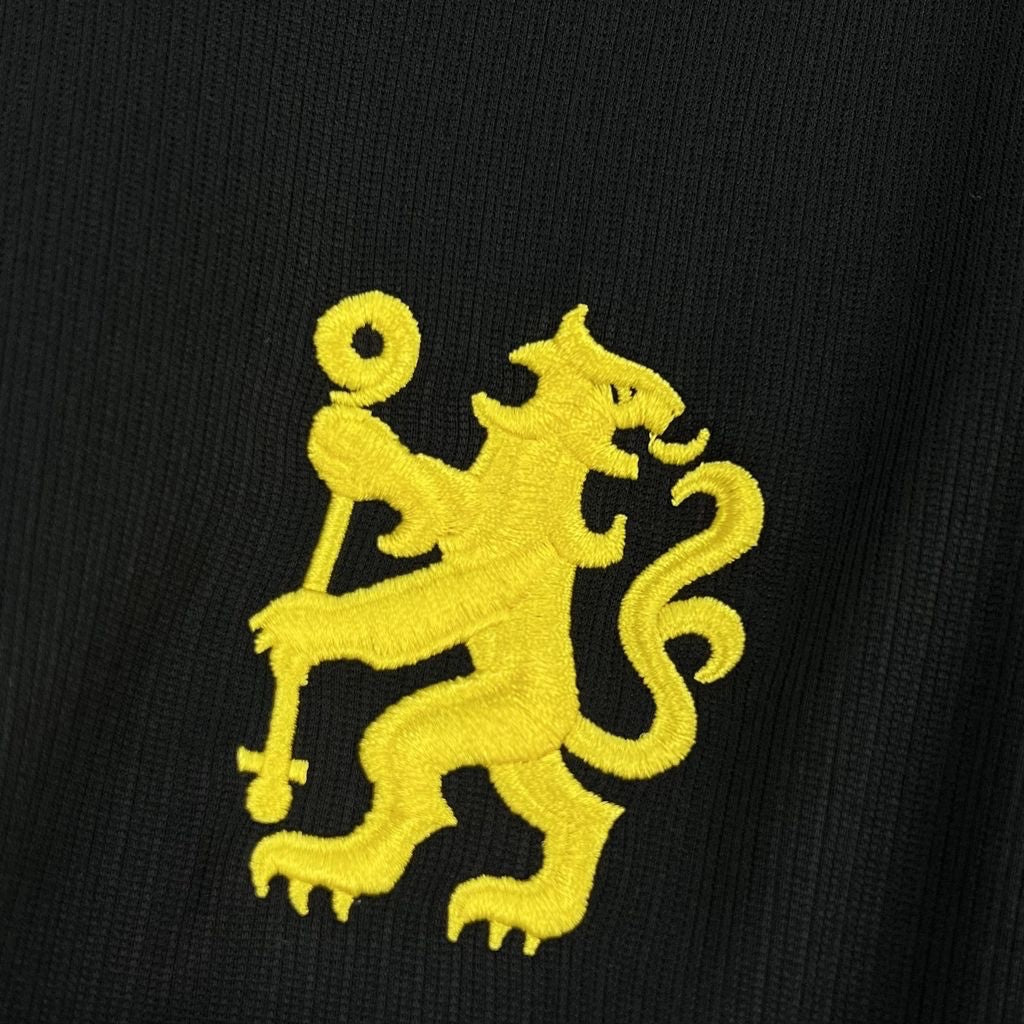 Leazofoot Chelsea 26/27 away jersey featuring a yellow embroidered lion crest on a black textured fabric background.