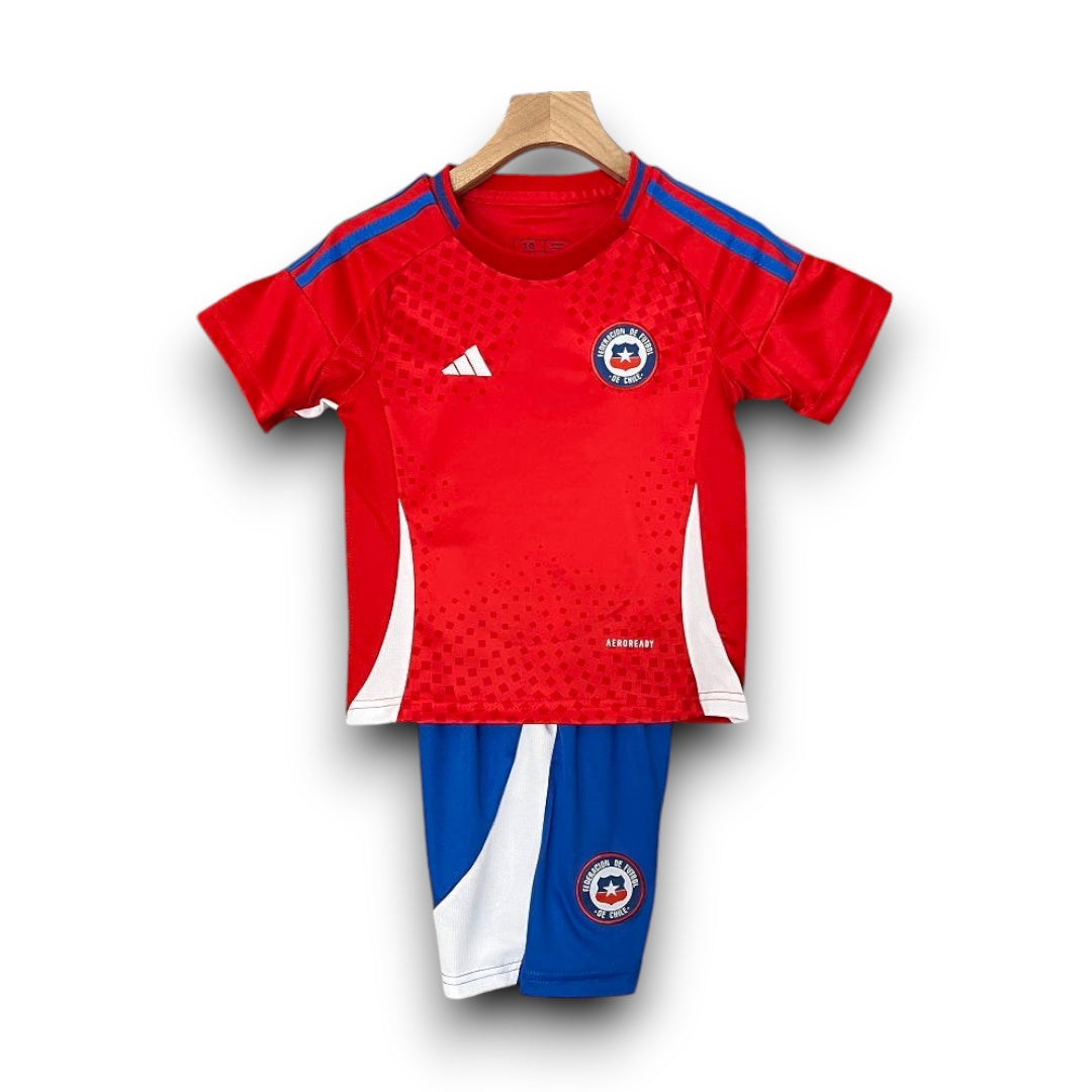 Leazofoot Chile 2024 home kids football kit featuring a red jersey with blue stripes and matching blue shorts.