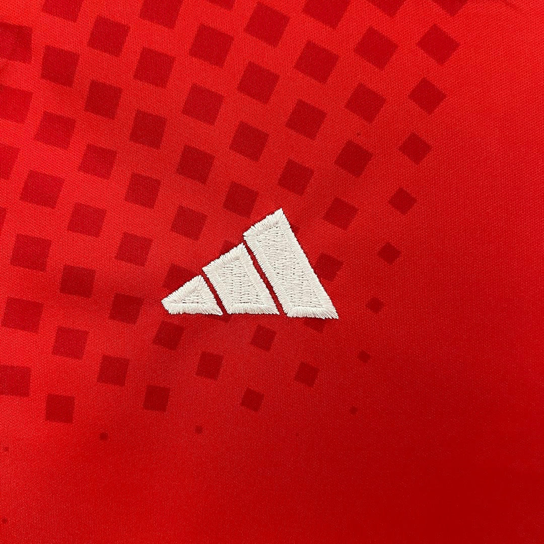 Leazofoot Chile 2024 kids home kit fabric with red square pattern and white embroidered logo detail.