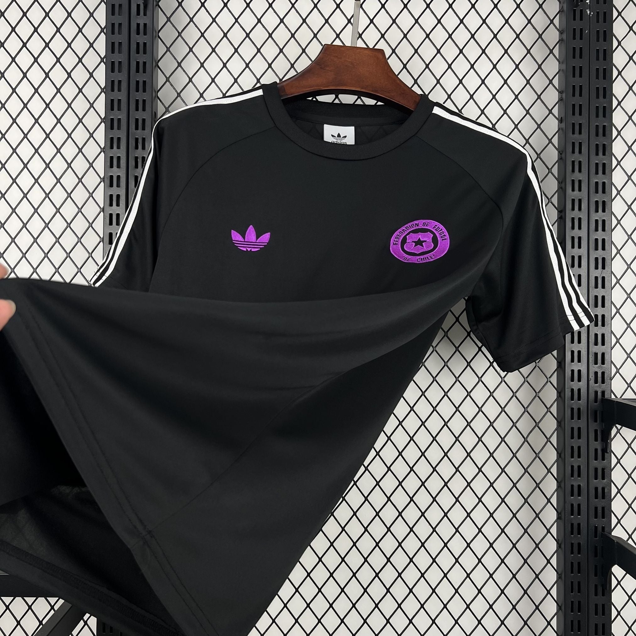 Leazofoot black Chile 2026 concept football jersey with purple logo and white sleeve stripes on a hanger.