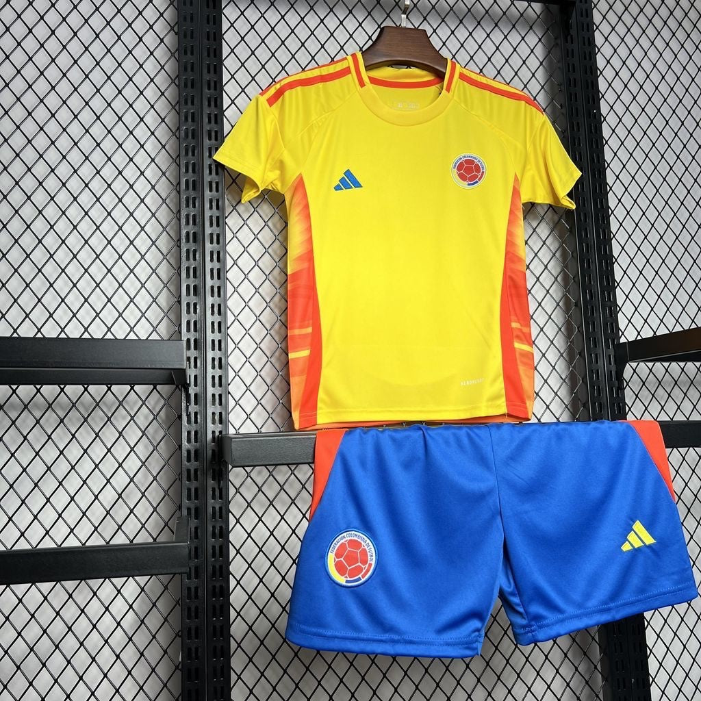 Leazofoot Colombia home football kit featuring a yellow jersey with orange accents and blue athletic shorts.