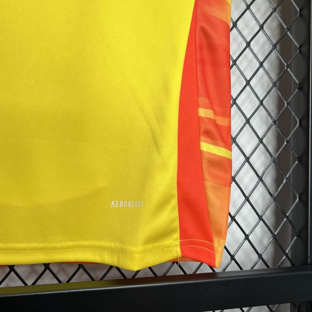 Leazofoot Colombia home jersey in yellow with orange side panel detail and AEROREADY moisture-wicking fabric.