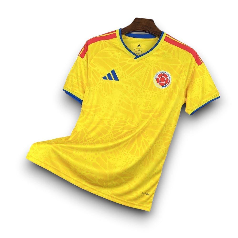 Leazofoot Colombia 2026 home soccer jersey. Yellow with blue trim and red accents. Features abstract pattern.