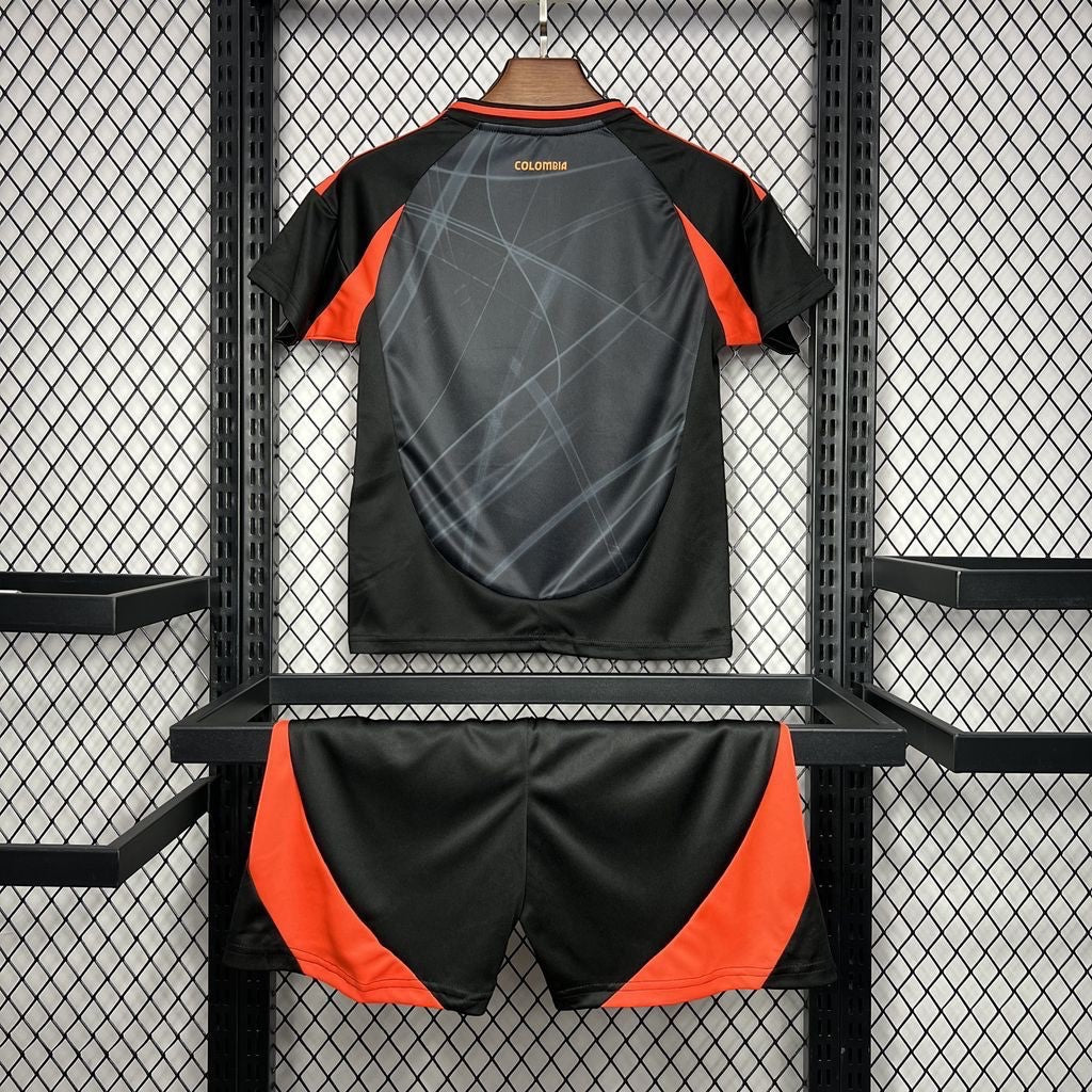 Leazofoot Colombia 2024 kids home soccer kit in black and orange with abstract graphic print on the jersey back.