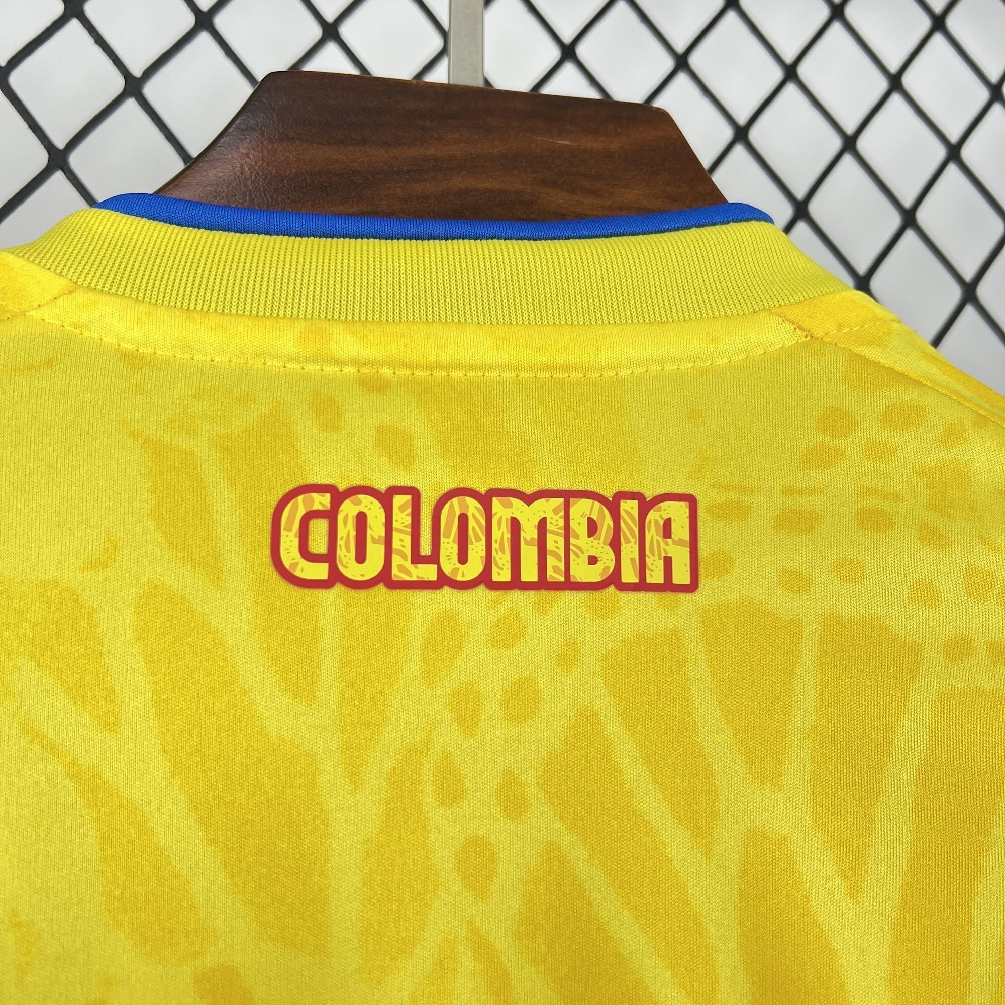 Leazofoot Colombia long sleeve home jersey 2026 in yellow with blue collar detail and subtle graphic pattern.