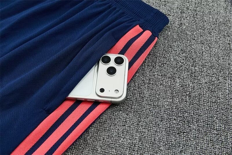 Leazofoot Colombia 2026 training shorts in navy blue with pink side stripes and a zippered pocket