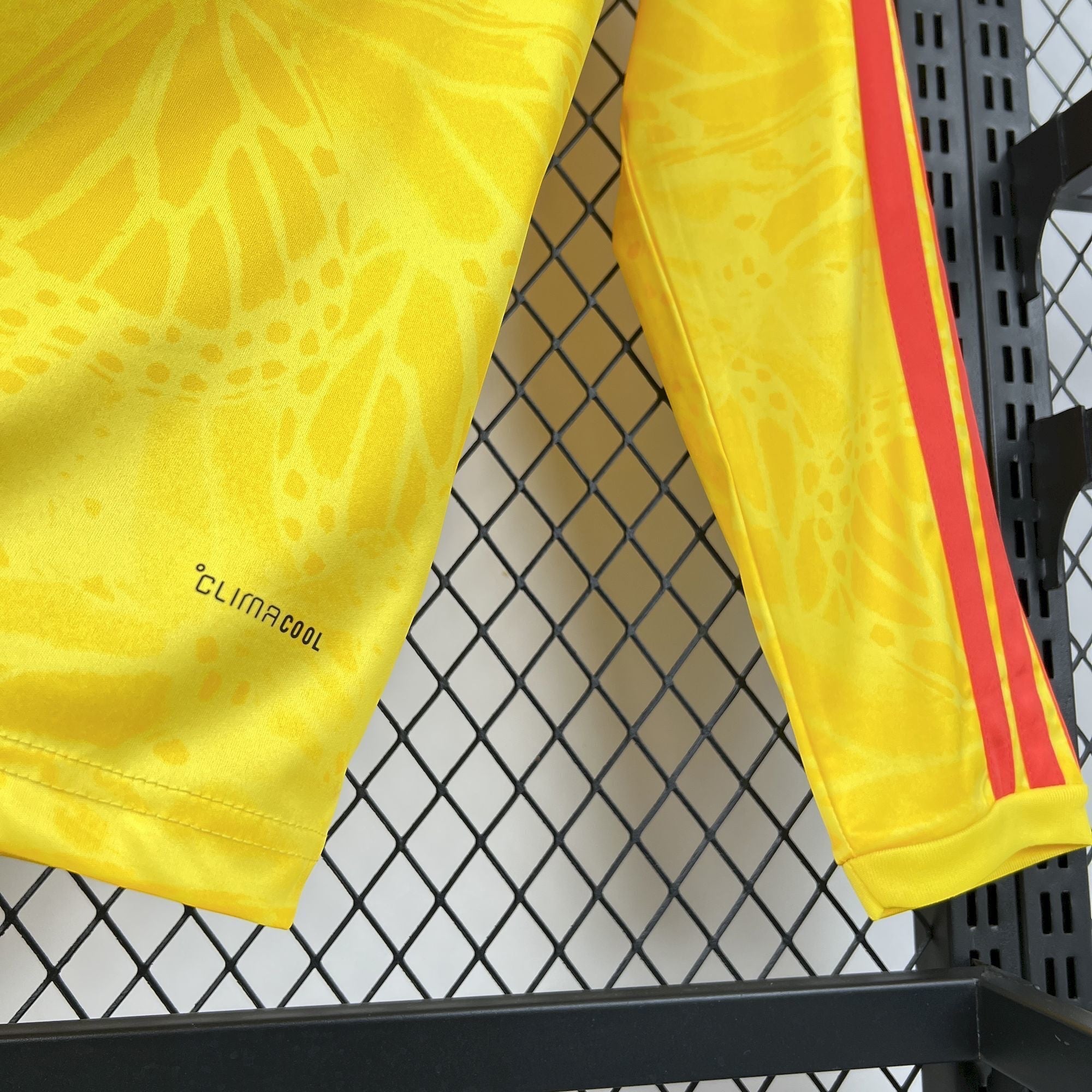 Leazofoot COLOMBIE long sleeve home jersey in yellow with red stripes and subtle graphic pattern. Features Climacool technology.