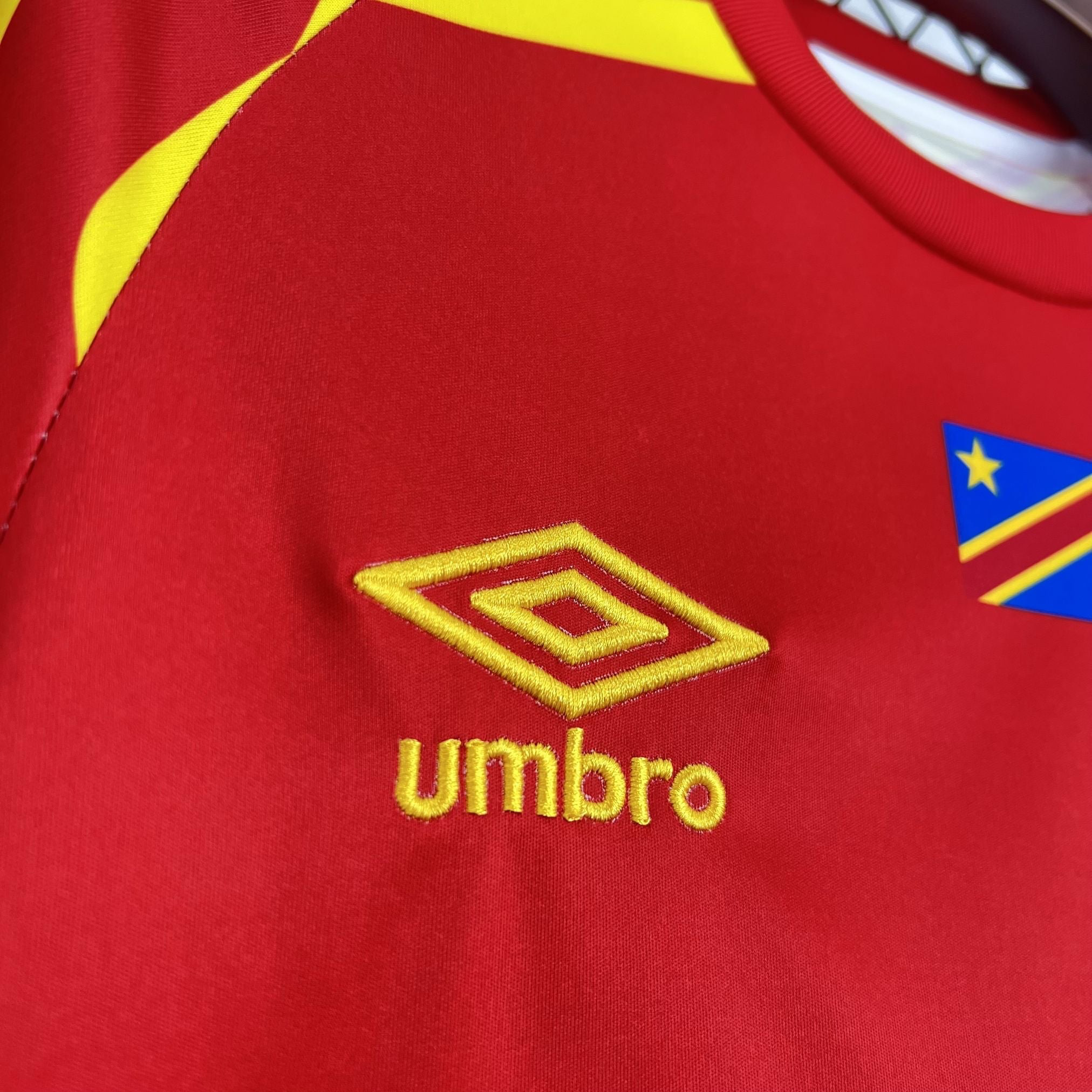 Leazofoot CONGO third football jersey 2026 in red with yellow trim and embroidered Umbro logo.