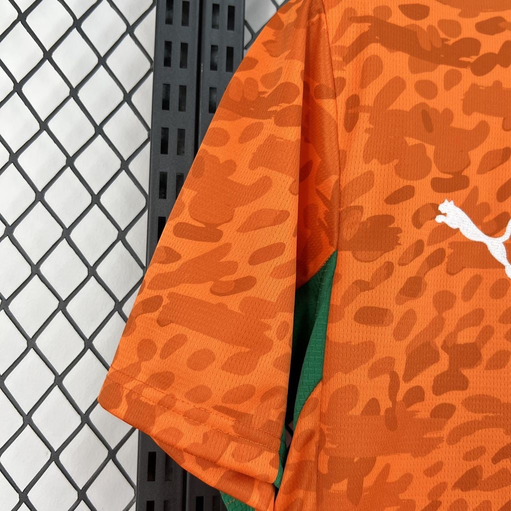 Leazofoot Côte d'Ivoire 2026 home jersey in orange with a patterned design and green side panels.