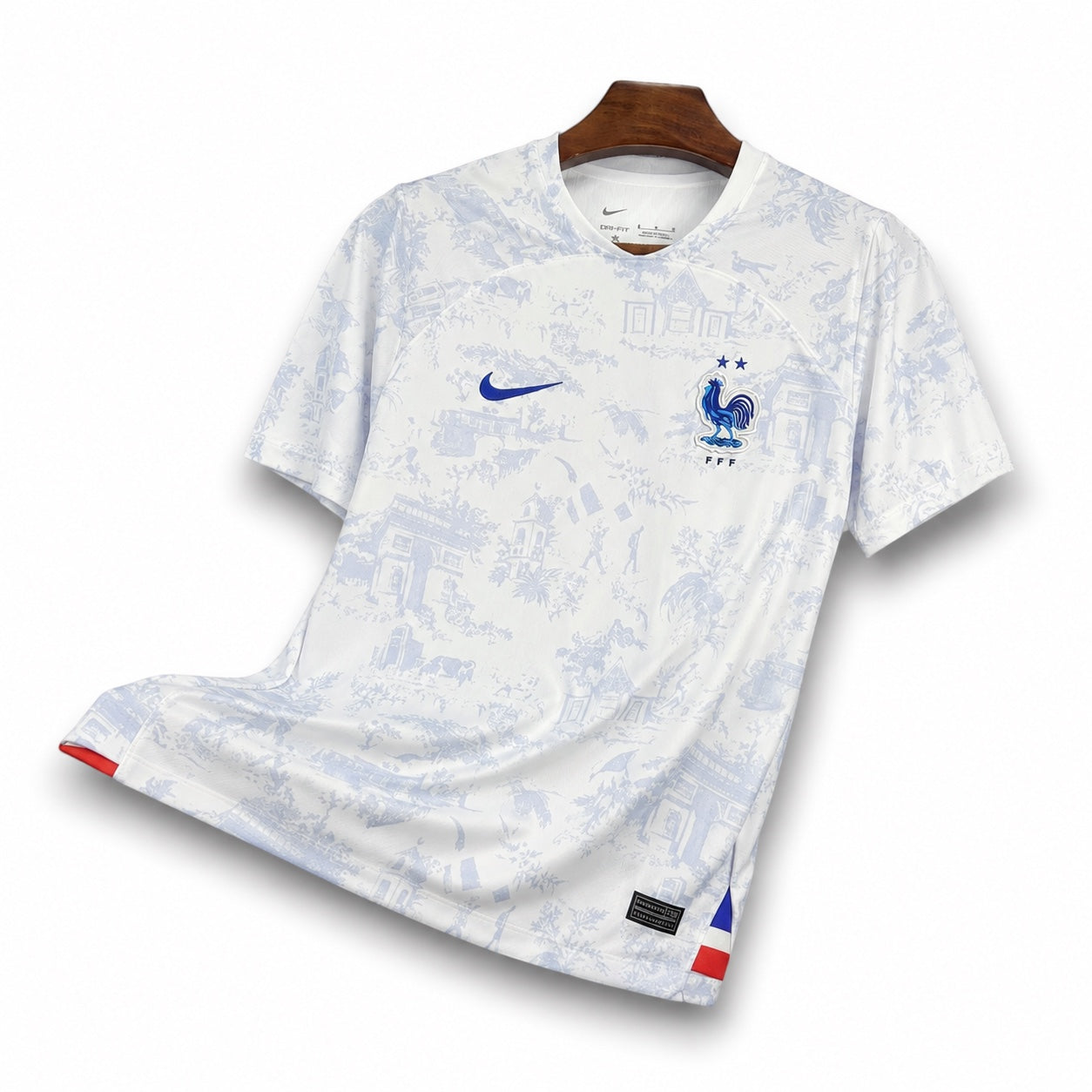 Leazofoot France 2022 away jersey in white with blue toile de jouy pattern, Nike logo, and FFF crest on a hanger.