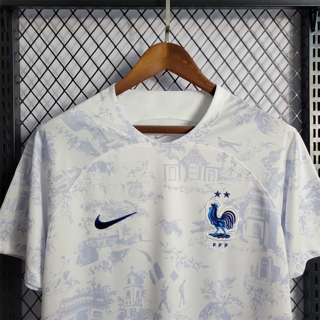 Leazofoot France 2022 away jersey in white with blue toile de jouy print, Nike swoosh, and FFF crest on a hanger.