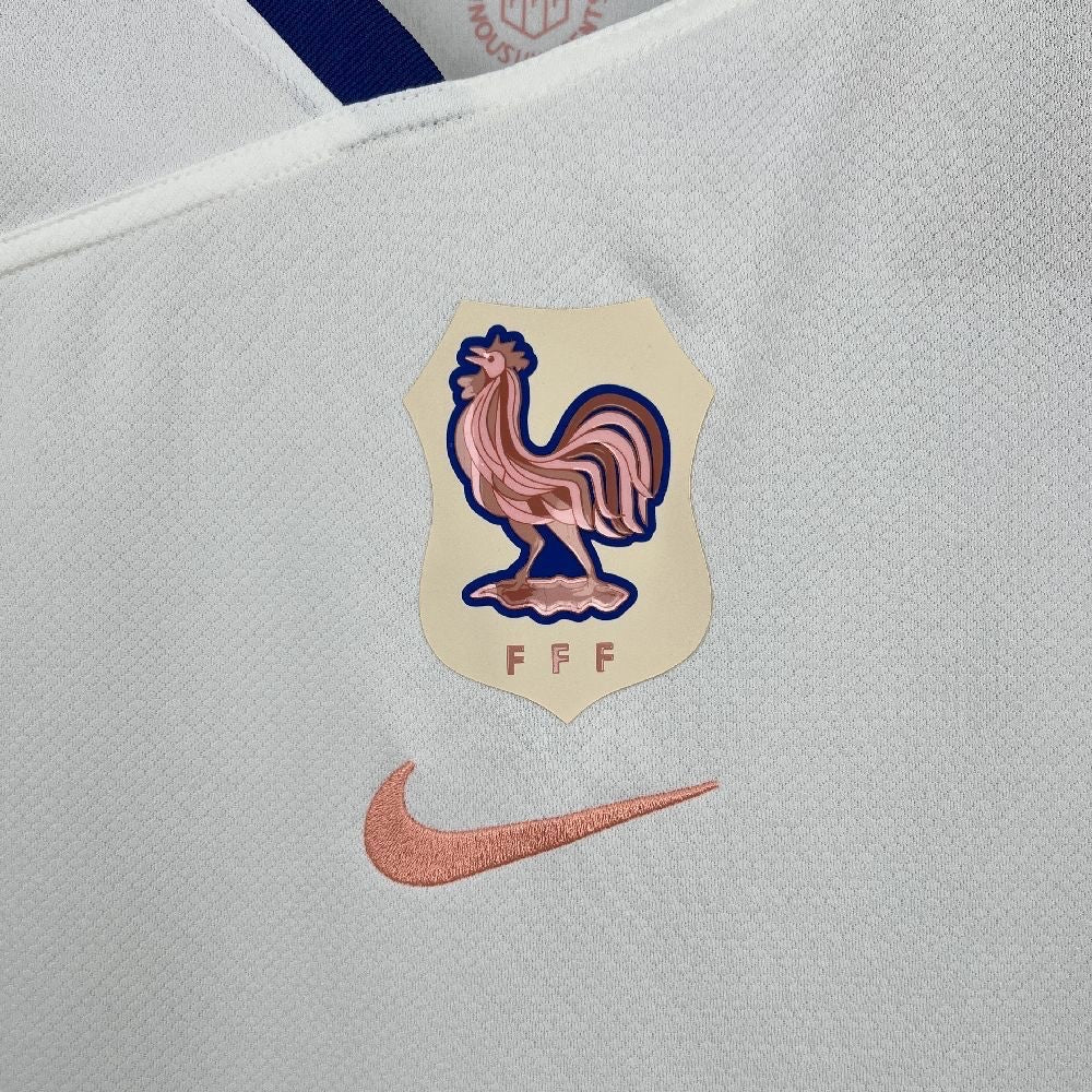 Leazofoot France 2025 away jersey featuring a white fabric, FFF rooster crest, and a copper-toned Nike swoosh logo.