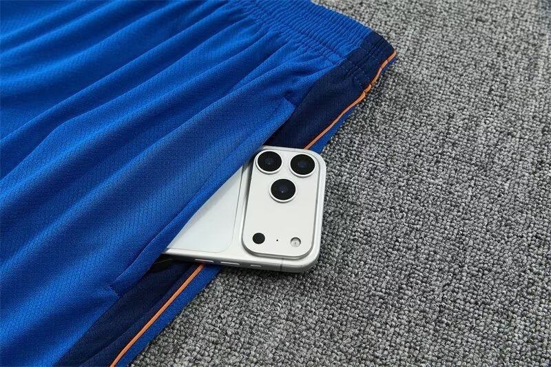 Leazofoot France 2026 training shorts in blue with a zippered pocket holding a smartphone