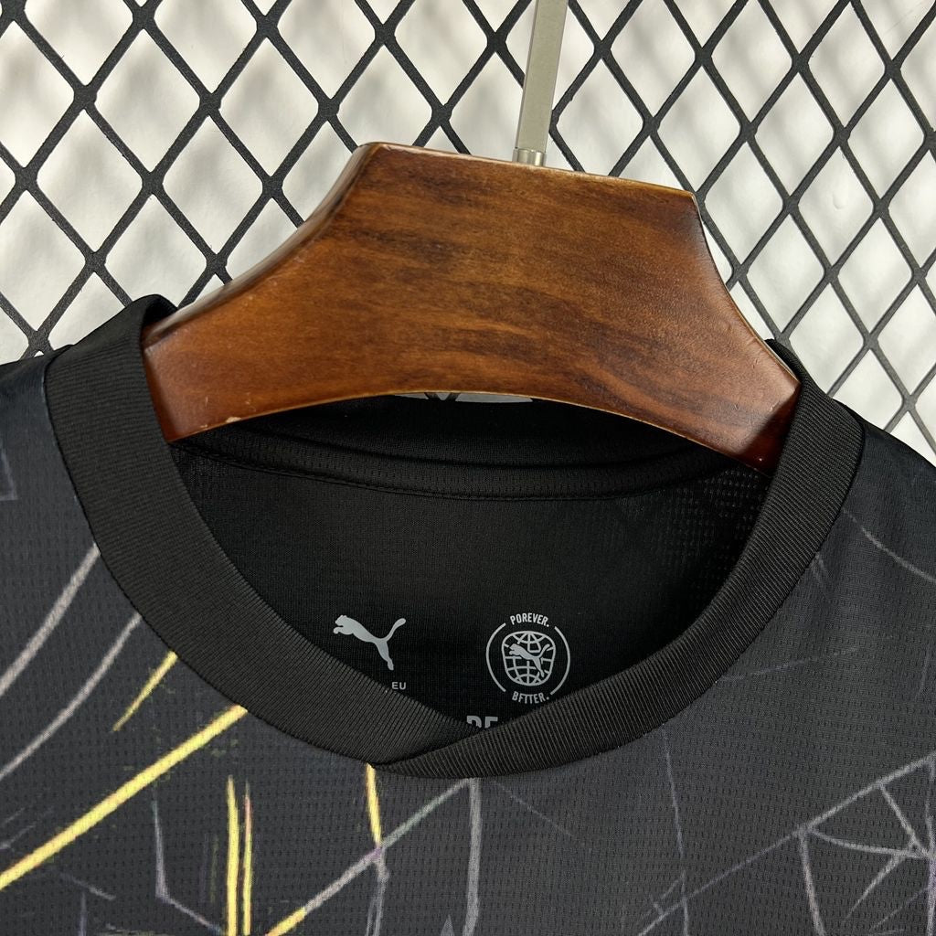 Leazofoot Ghana 2026 third soccer jersey in black with yellow and white abstract graphic patterns on a hanger.