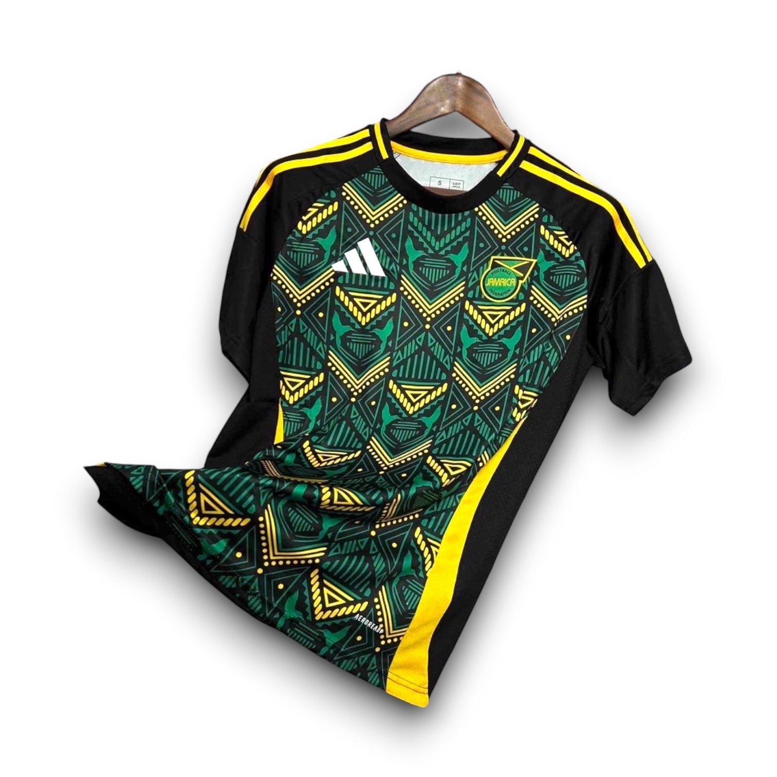 Leazofoot Jamaica 2024 away football jersey in black, green, and yellow with a geometric pattern and team crest.