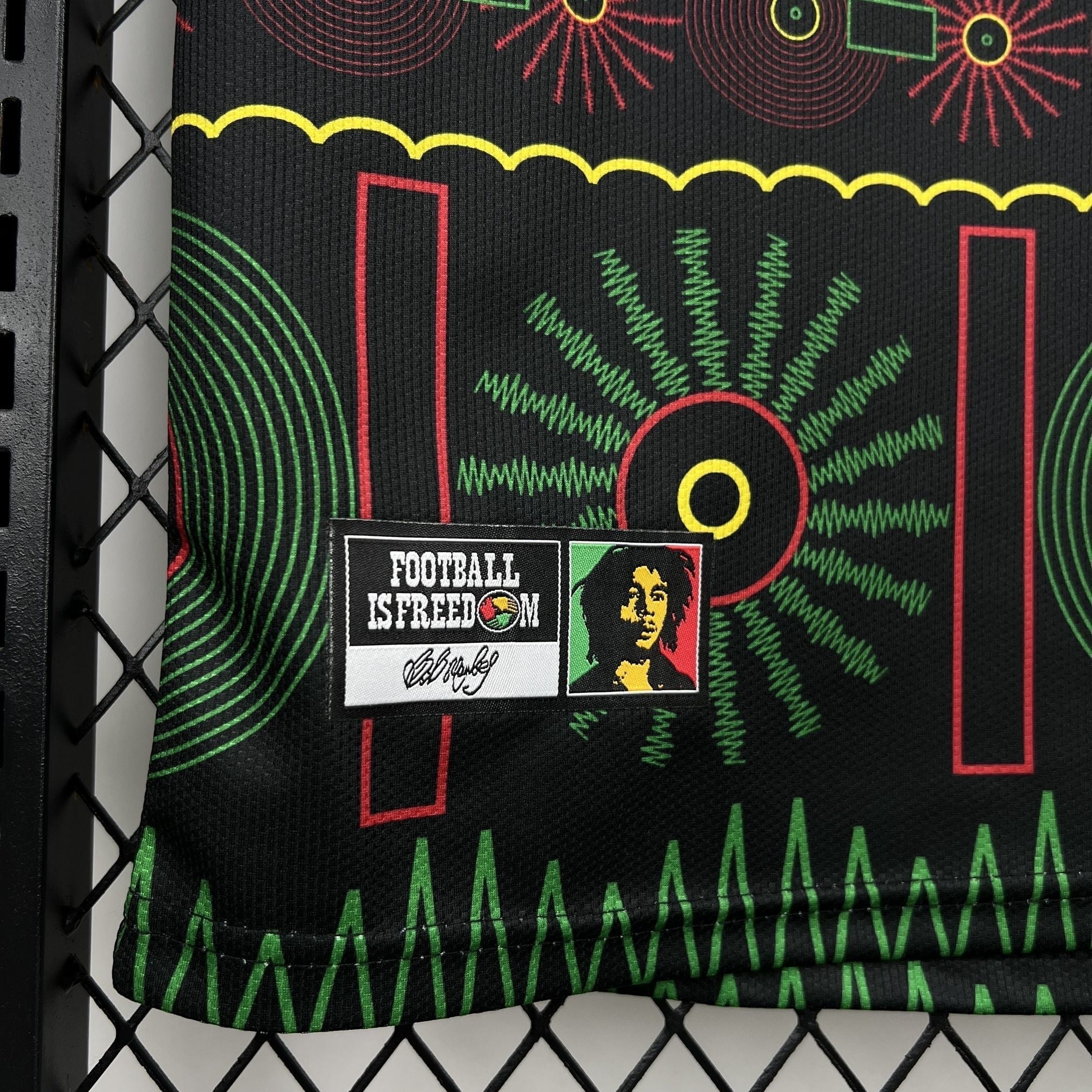 Leazofoot Jamaica 2026 away football jersey featuring Bob Marley graphic and Football Is Freedom patch on black fabric