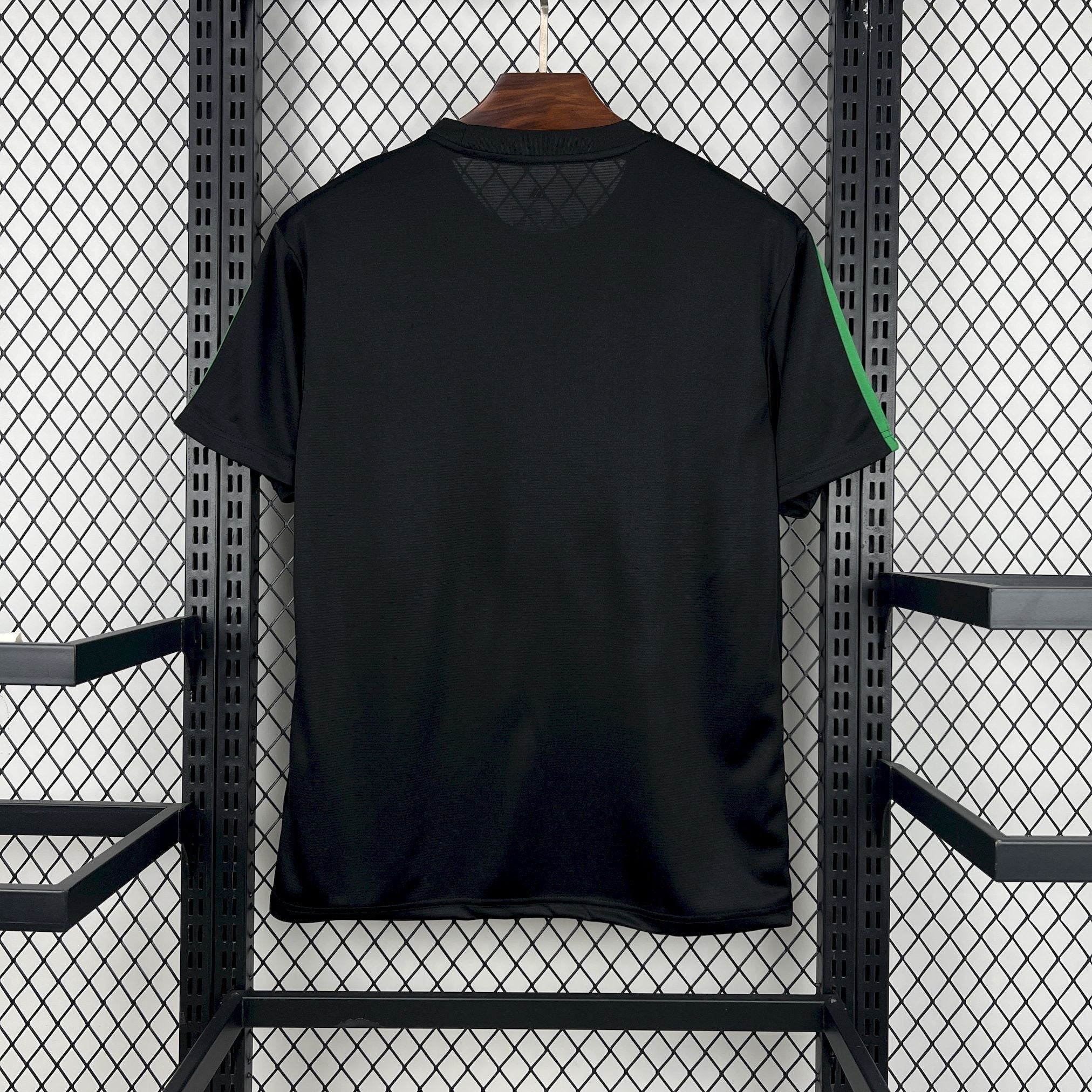 Leazofoot Jamaica 2026 concept soccer jersey in black with green side stripes, back view on a hanger.