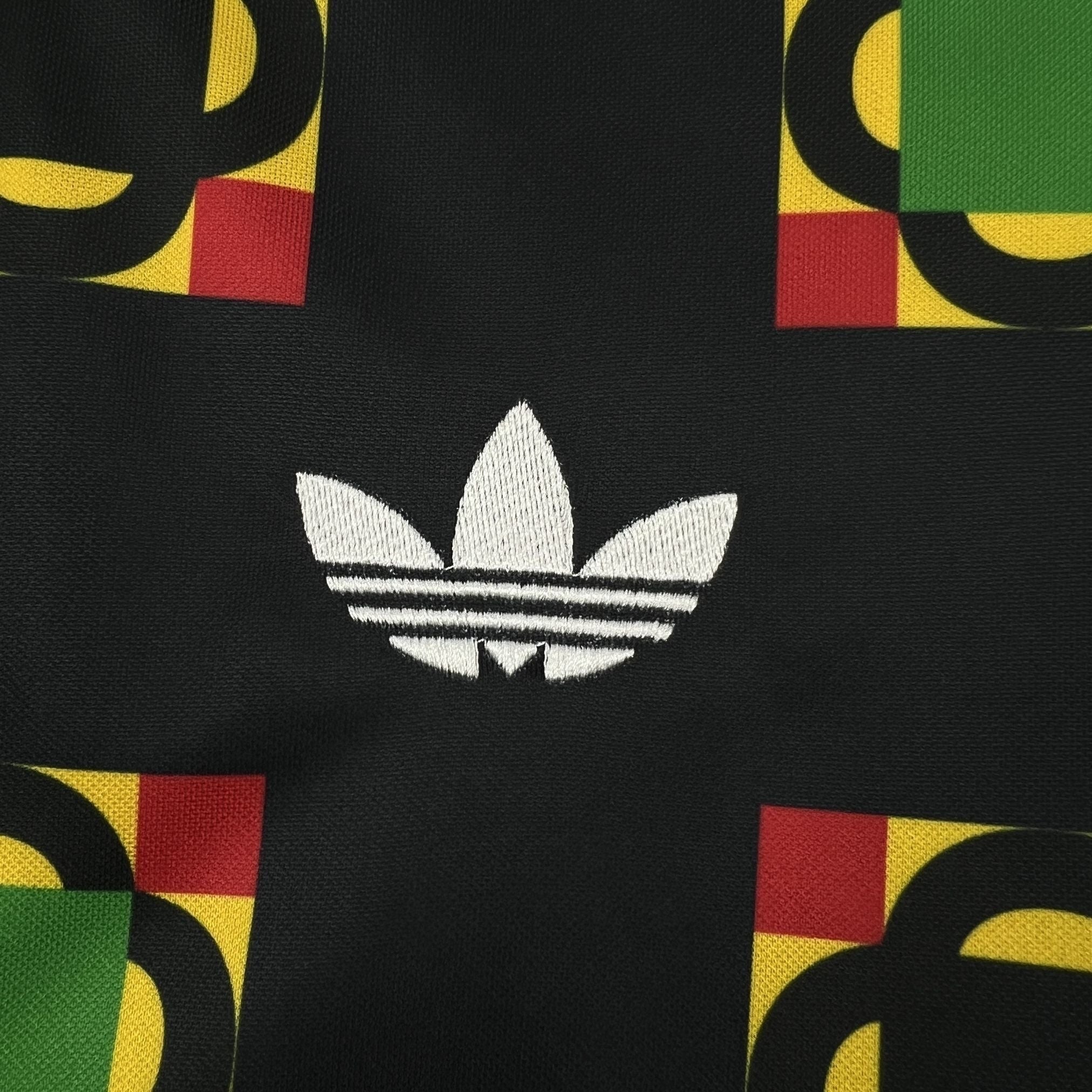 Leazofoot Jamaica 2026 concept soccer jersey featuring a black fabric with green, yellow, and red geometric patterns.