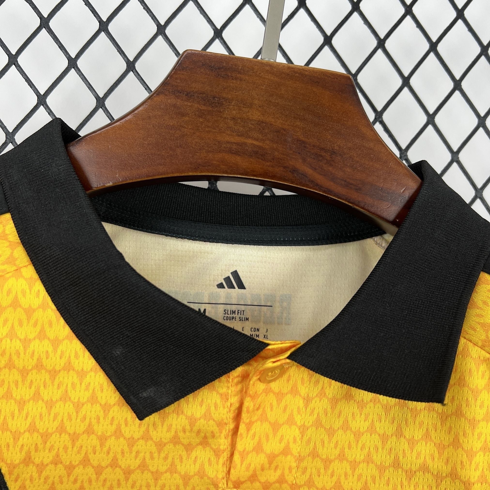 Leazofoot Jamaica 2026 home soccer jersey featuring a yellow textured pattern and a black polo collar.
