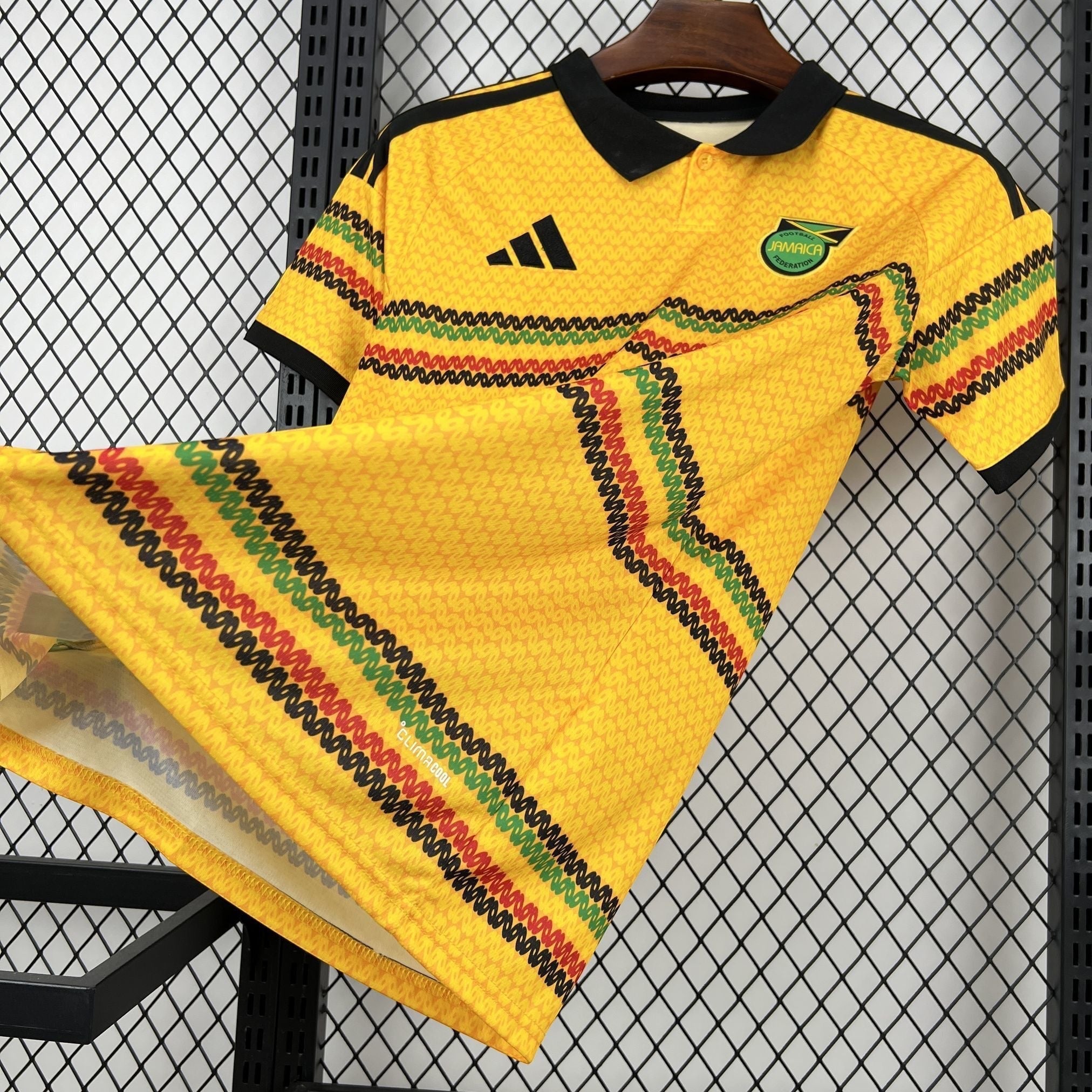 Leazofoot Jamaica 2026 home football jersey in yellow with black collar and red, green, and black graphic patterns.