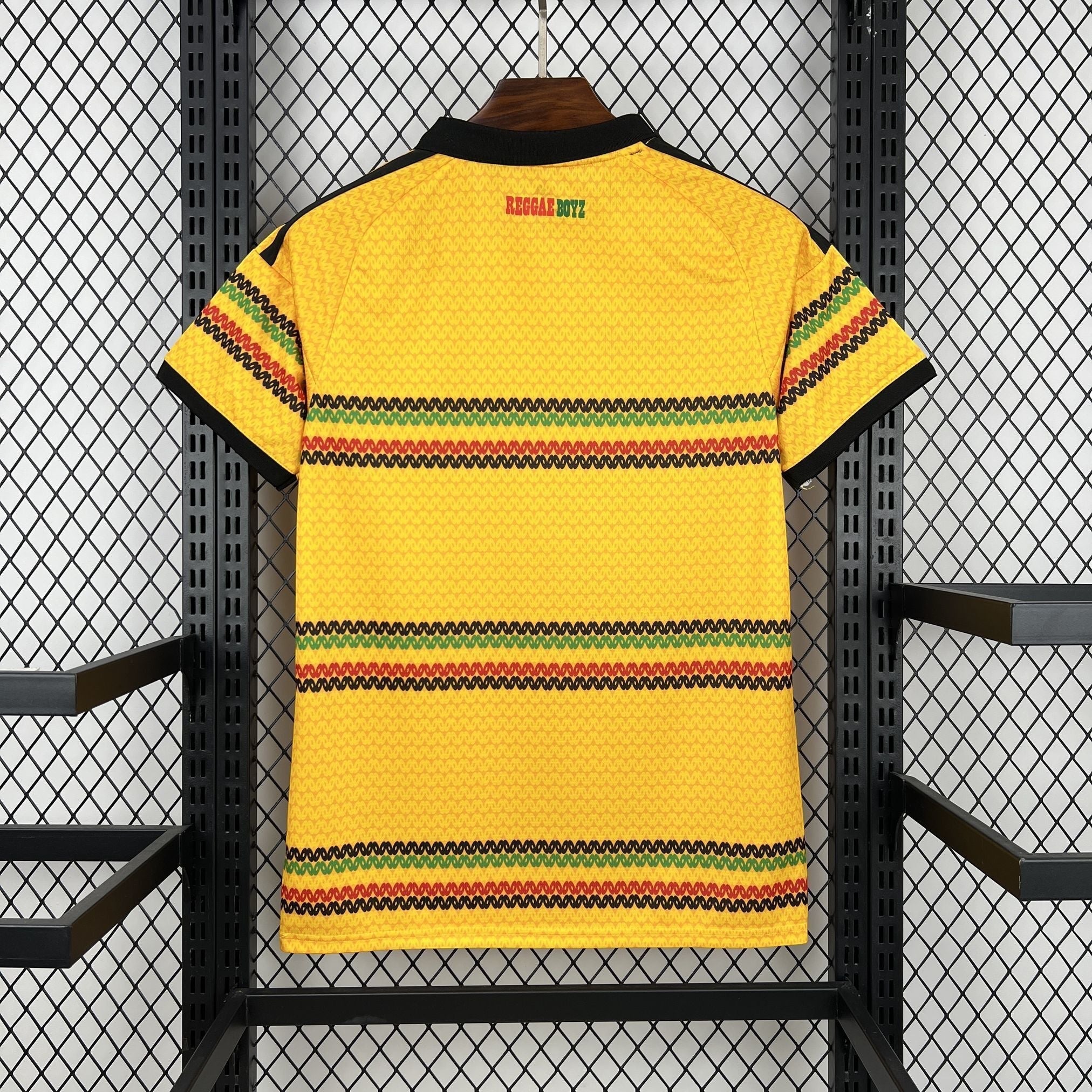 Leazofoot Jamaica 2026 home soccer jersey in yellow with black, green, and red striped details and Reggae Boyz text.