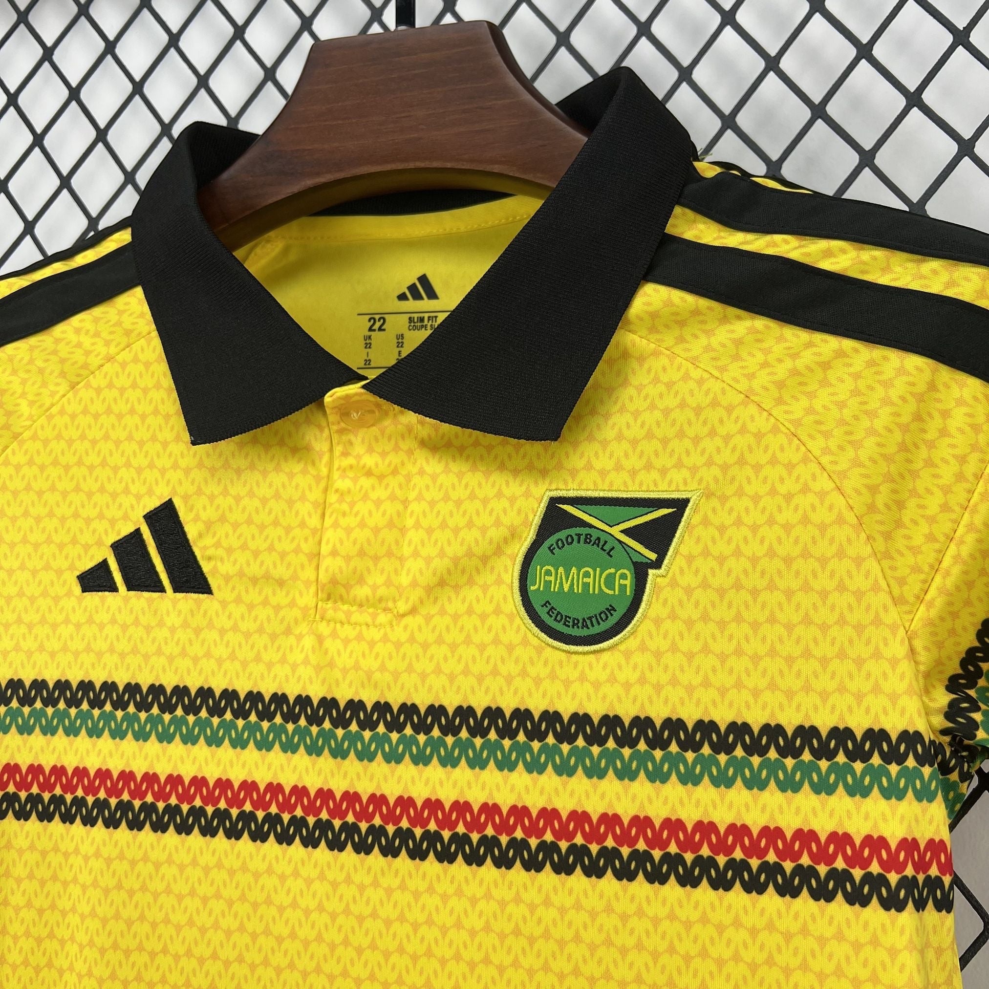 Leazofoot Jamaica 2026 home kids football jersey in yellow with black collar and green, red, and black stripe detail.