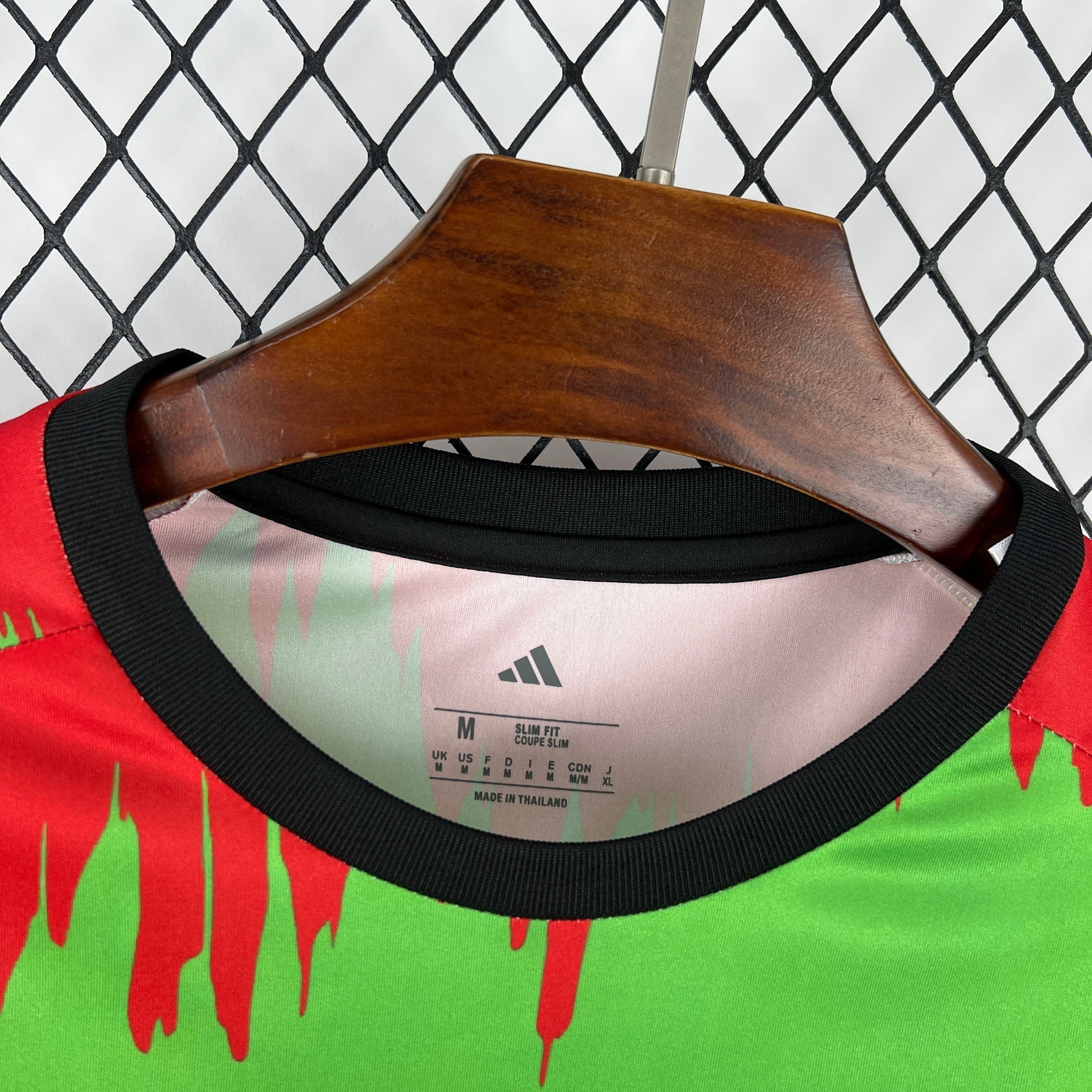 Leazofoot Jamaica 2026 pre-match football jersey featuring a vibrant red and green graphic pattern with black trim.