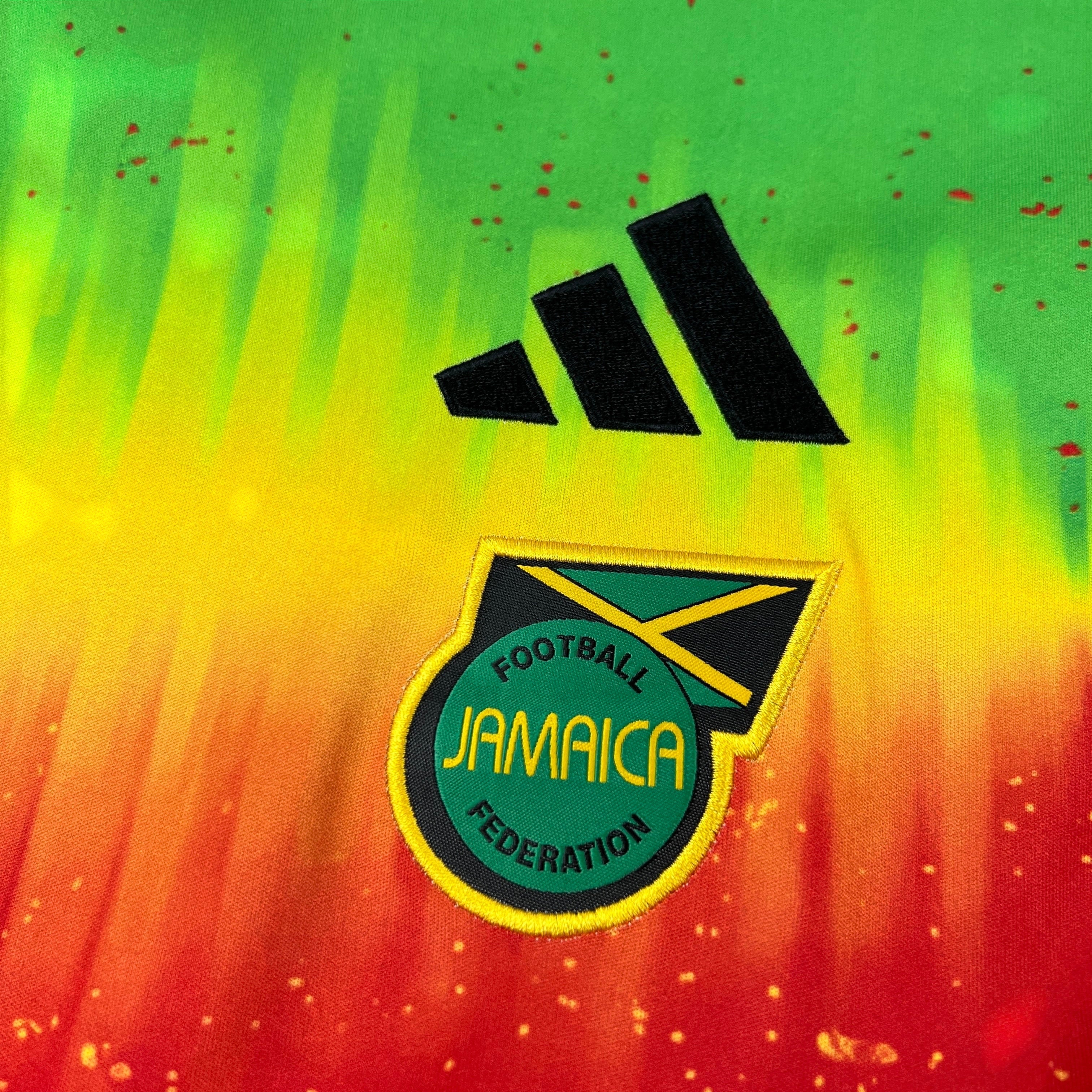 Leazofoot Jamaica 2026 pre-match football jersey featuring a vibrant green, yellow, and red gradient pattern.