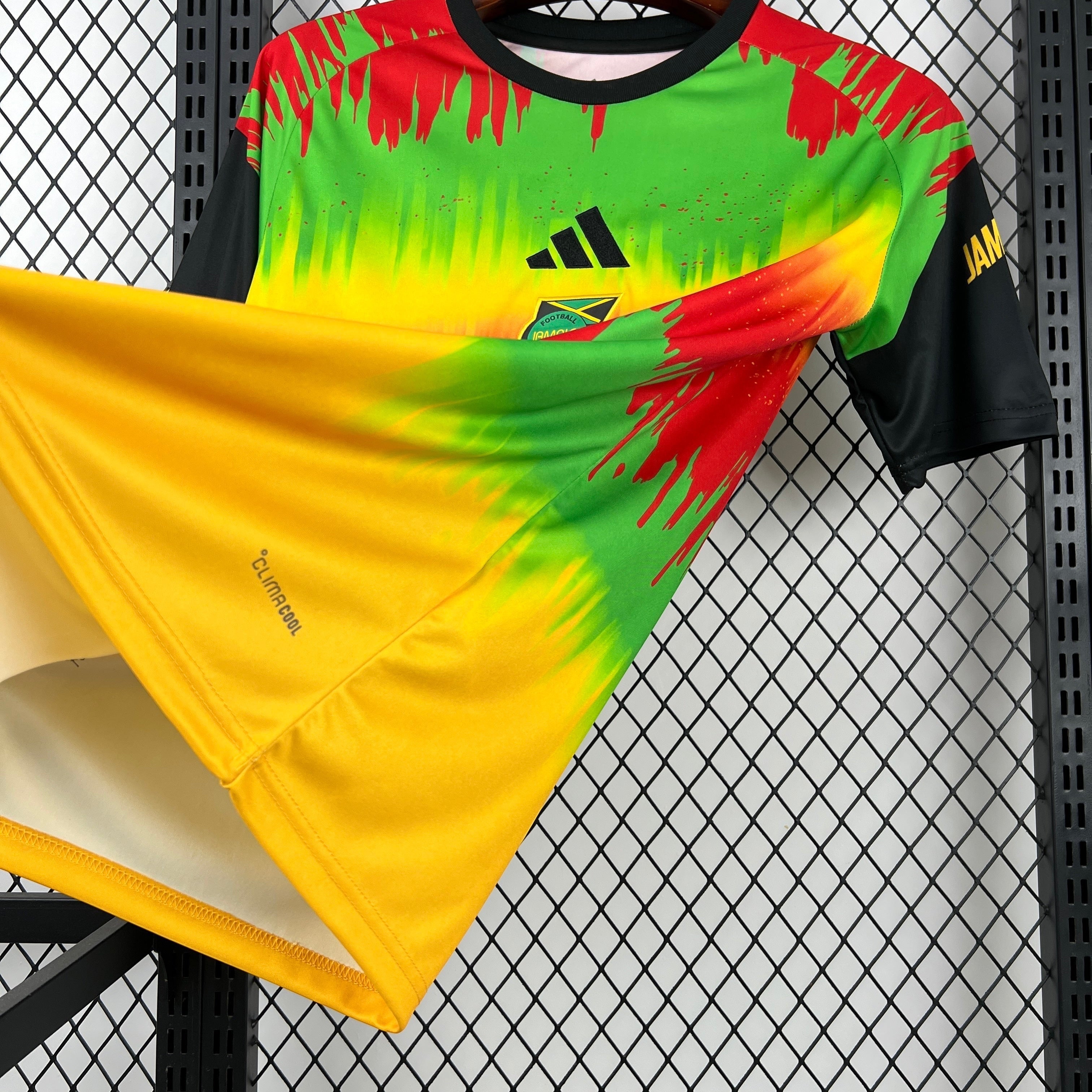 Leazofoot Jamaica 2026 pre-match football jersey featuring a vibrant green, yellow, and red paint-splatter design.