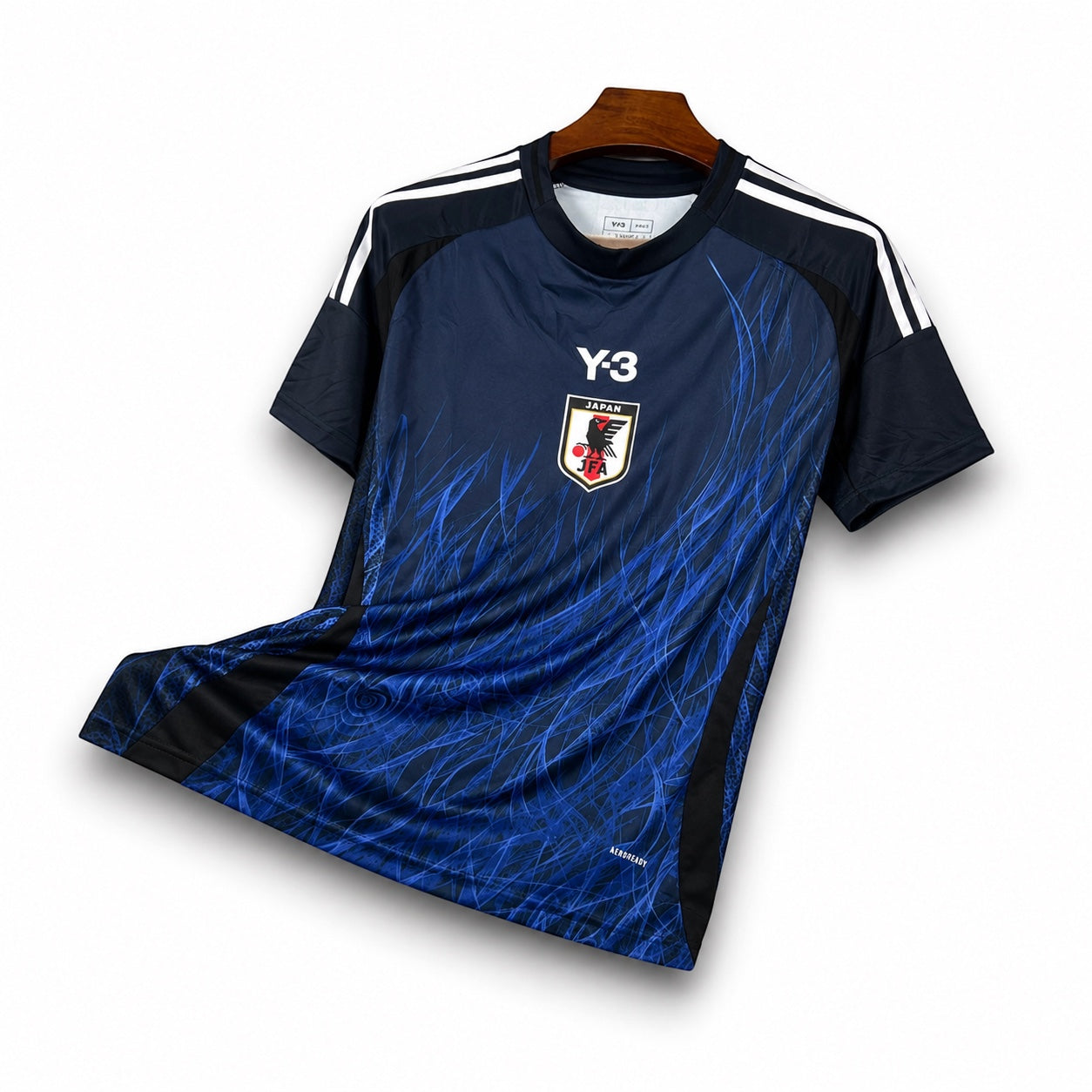 Leazofoot Japan 2024 home football jersey in blue with Y-3 branding, JFA crest, and abstract flame graphic print.
