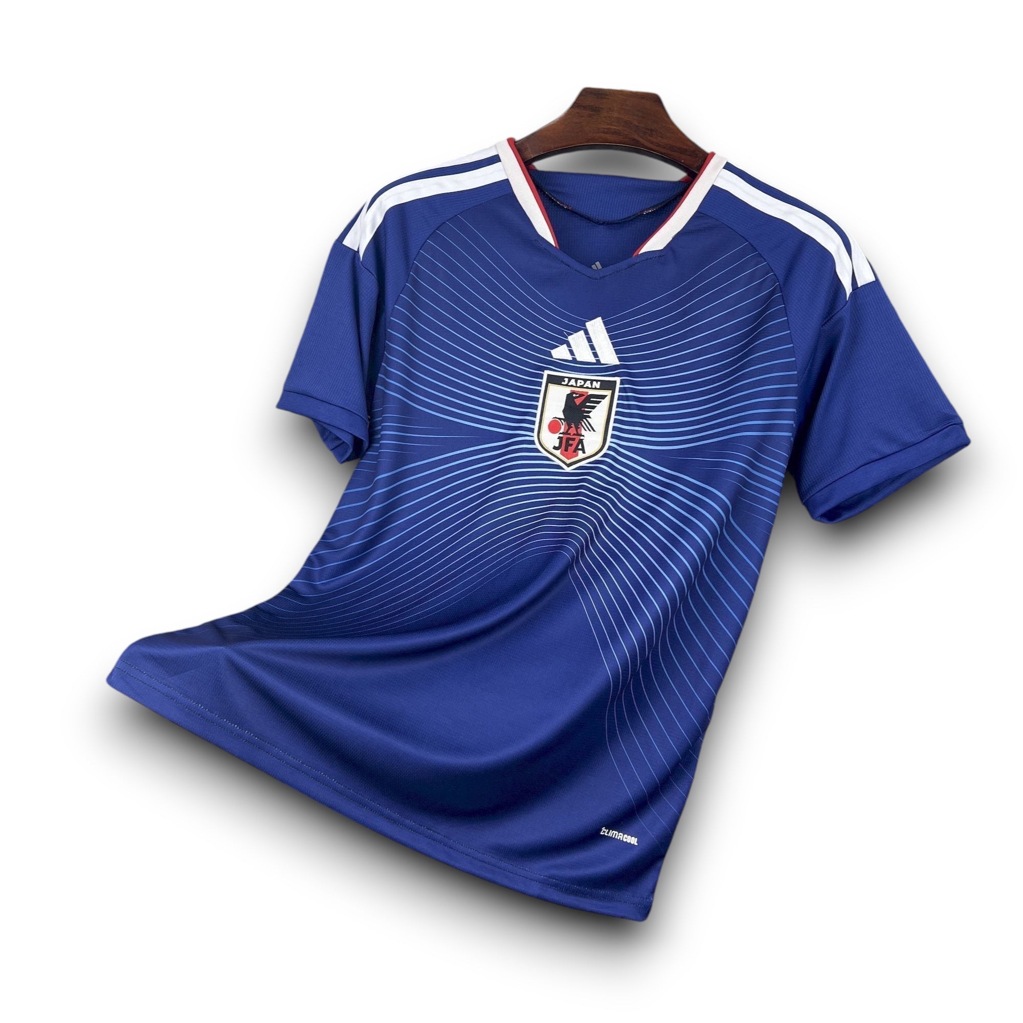 Leazofoot Japan 2026 home soccer jersey. Blue with white stripes on shoulders and a graphic pattern.